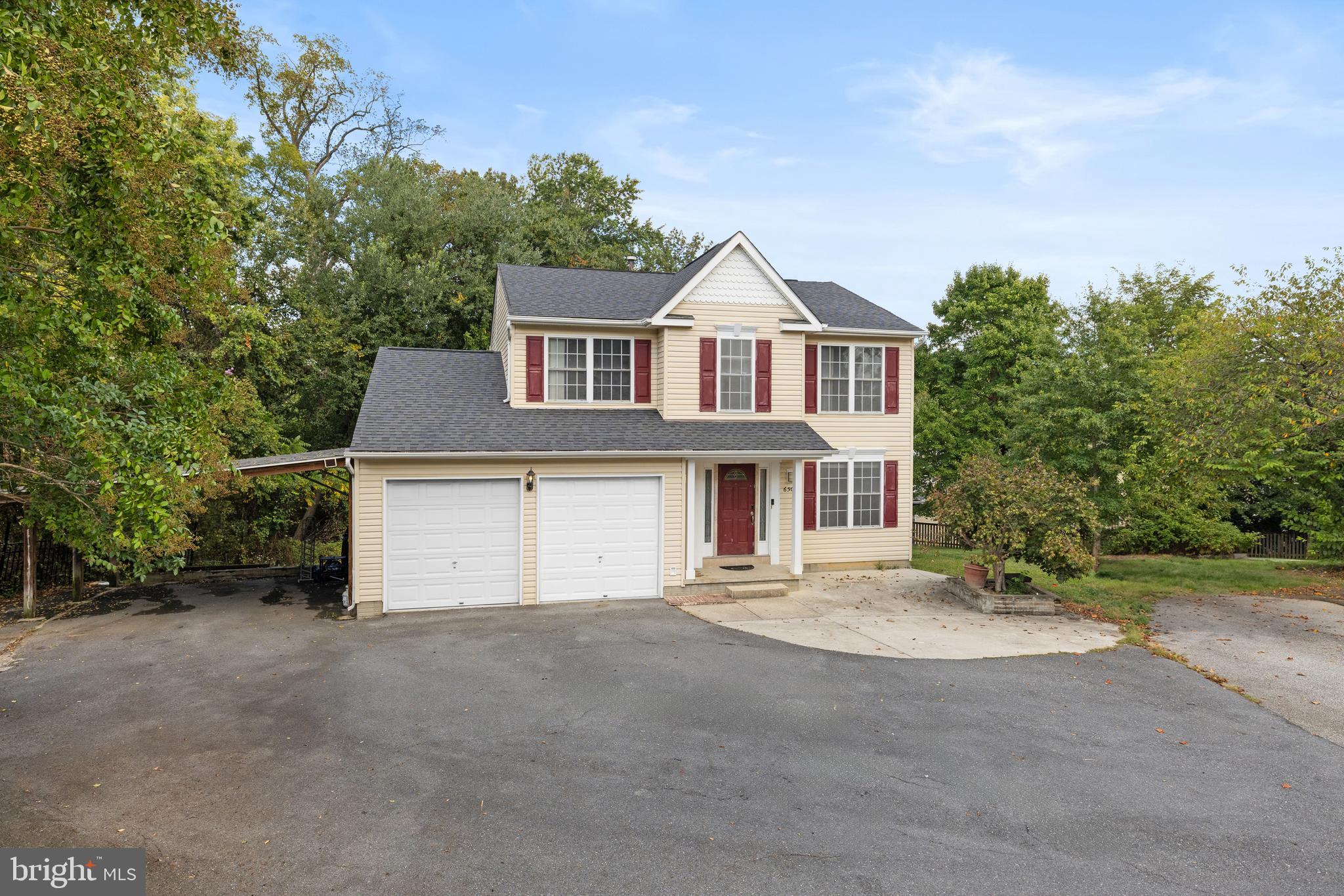 Check it out! Four bedroom and two and a half bath colonial with spacious master bedroom with walk-in closet. This home features 2 sunrooms and a deck, walk-out basement, large family room in the basement for family gathering. The entire home is freshly painted, new dishwasher and stove installed. The roof was replaced in 2019, HVAC replaced in 2019, and washer and dryer replaced in 2023. The home has double garage and additional parking spaces in carport and driveway that can park up to 5 vehicles. Close proximity to shopping plaza . Close to route I-95/495.