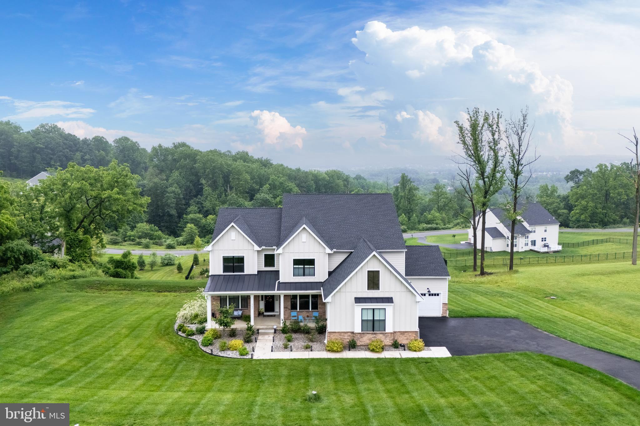 NEARLY NEW and thoughtfully designed for today’s lifestyles, this 5 BEDROOM, 4.5-BATH home in the highly desirable SOUTHERN LEHIGH School District blends function and style across every level, with close to a HALF-MILLION in PREMIUM ENHANCEMENTS and CUSTOMIZATIONS since 2022 purchase. The open FOYER with HARDWOOD FLOORS flows into a cozy sitting room, LIBRARY/STUDY with glass-paneled French doors, and a versatile HOME OFFICE/PLAYROOM. The gourmet kitchen features a large center island, CUSTOM CABINETRY, QUARTZ COUNTERTOPS, PREMIUM APPLIANCES, WALK-IN PANTRY, and BUTLER’S PANTRY, offering a CLEAN, MODERN AESTHETIC with exceptional prep and storage. Just off the kitchen, access the 2ND-STORY TREX DECK—perfect for outdoor dining and peaceful backyard views. The MUDROOM includes built-in storage, one of TWO DOG WASHING STATIONS, and entry to both the TWO-CAR and SINGLE-CAR GARAGES. The FAMILY ROOM impresses with SOARING CEILINGS, PANORAMIC VIEWS, and GAS FIREPLACE—a welcoming space for everyday comfort. Upstairs, the PRIMARY SUITE features WALK-IN CLOSETS, TRAY CEILING, and SPA-LIKE BATH with SOAKING TUB + WALK-IN SHOWER, alongside 3 more bedrooms, 2 bathrooms, and LAUNDRY ROOM. The BEAUTIFULLY FINISHED LOWER LEVEL includes a 5TH BEDROOM, 4TH FULL BATH, 2ND LAUNDRY SETUP, KITCHEN with WINE FRIDGE, DOG WASH STATION #2, CUSTOM KIDS’ PLAYHOUSE, and SOUNDPROOF STUDIO for music or content creation. A WHOLE HOUSE GENERATOR provides added peace of mind. This home is truly ONE-OF-A-KIND.