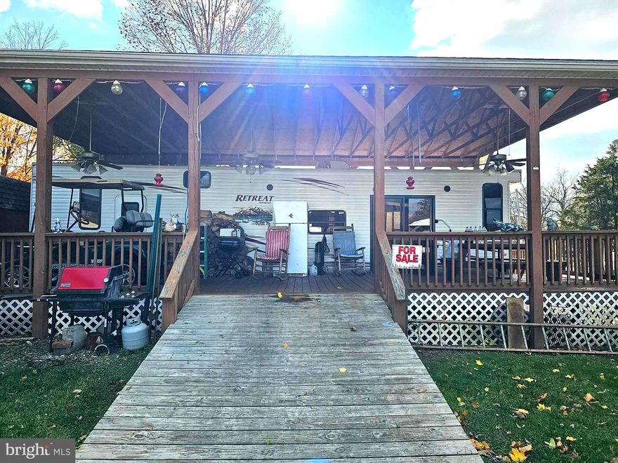 This property is located within RIVER BEND CORPORATION in Falling Waters WV.  This property can only be used from April until November 1st of each year.  The RV has been under roof cover practically since being place within the campground.  Some furniture within the RV conveys with the purchase of the property.