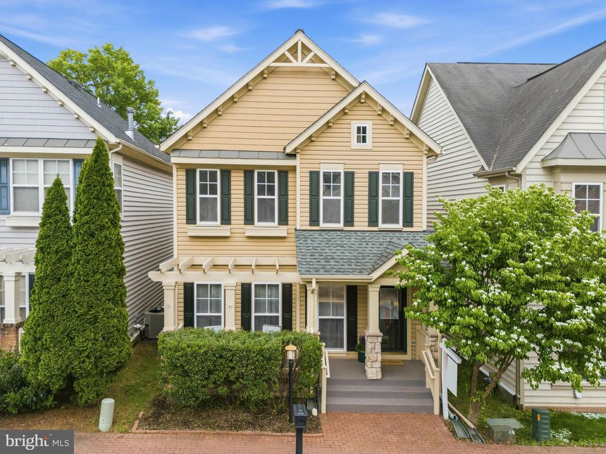 Nestled on a quiet street in the highly sought-after Lorton Town Center community, this beautifully maintained single-family home is a true commuter’s dream. With a rear-loading two-car garage and a charming exterior that lives much larger than it appears, this home offers an impressive amount of space, natural light, and flexibility throughout.

Enjoy a welcoming front porch before entering the sunlit main level, where the living and dining areas feature gleaming hardwood floors, custom lighting, a gas fireplace, and an easy flow that is perfect for everyday living and entertaining. Large windows overlook the private, cozy fenced slate patio, creating a bright and inviting setting. The upgraded kitchen showcases white cabinetry, granite countertops, stainless steel appliances, a wine refrigerator, and a convenient breakfast bar ideal for casual meals.

A rare and highly desirable feature of this home is the private main-level bedroom suite with a full bathroom, tucked away from the other bedrooms and living areas—perfect for guests, an au pair suite, or multigenerational living. Upstairs, the spacious primary suite offers an incredible custom closet with built-in shelving and an updated bath with a freestanding soaking tub, glass enclosed shower, custom tile work, granite countertops, upgraded extended-height cabinetry, and enhanced lighting. Two additional upper-level bedrooms with spacious closets and a full hall bath complete the upper level.

The finished lower level offers brand new carpet throughout a huge recreation room plus two flexible rooms that can serve as a home office, gym, guest space, hobby room, or additional storage. 

Notable updates and features include a 2018 roof, brand-new hot water heater in 2026, Carrier HVAC 2013, radon mitigation system, and an extra subpanel already installed for a future EV charger, generator, or other electrical needs. Ideally located, this home is just minutes from restaurants, shops, major commuter routes, I-95, Fort Belvoir, and Washington, DC.