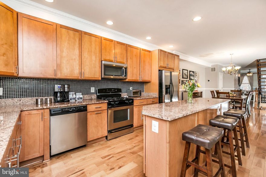 Beautiful total renovation in excellent condition with 4 finished levels in Locust Point! The 1st floor has an open layout with separate living & dining rooms, a powder room and a spacious kitchen that leads to the rear patio perfect for your outdoor entertaining. The kitchen has stainless appliances, granite counters and plenty of cabinet space. The 2nd level has the laundry room & 2 bedrooms each with full bathrooms. The 3rd level is where you'll find the master bedroom & bathroom, walk-in closet, rough-in for a wet bar and hallway access to a rear deck that leads the rooftop deck! The fully finished lower level has a full bathroom and is the full length of the house with an additional entry/exit at the rear. This space is perfect for an additional family/play room, home office or the 4 bedroom. Roof replaced in 2019.