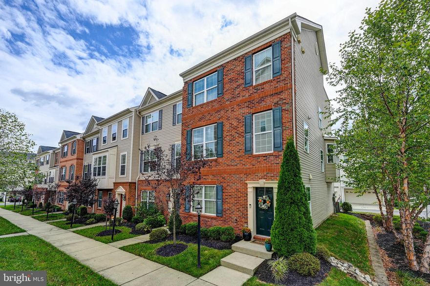 If you're looking for your next home to look like a Model Home you've just found it!  Located in the highly desirable Oxford Square community...... Come check out this Immaculate 4 Level brick front, 2 car garage, 4 bedroom, 3 full bath, 2 half bath, End Unit garage Townhouse with loft / bedroom and Roof Top Deck!  Home shows pride of ownership.  Beautiful hardwood floors on first two levels.  Lower level offers an open family room and/or office/study space, which could also be converted to an additional bedroom, as well as a full bathroom.  Main level offers a great open floor plan with a gourmet kitchen with Island, granite countertops, stainless appliances, and table space.  Also includes a big open Living Room area and a half bath.  Third level includes a big roomy Primary Bedroom and bathroom, 2nd and 3rd bedroom, additional full bathroom, as well as laundry room.  Go up to the 4th level to a big open loft (or additional bedroom if you'd like), and walk out to the amazing roof top deck that is perfect for entertaining and relaxing.  4th level also includes a half bath and plumbing rough-in if you'd like to add a wet bar!  Residents of this townhome have the added bonus of a community pool, perfect for summertime relaxation, as well as a great gym, walking trails, and a clubhouse. The location is truly exceptional, offering easy access to shopping, restaurants, and parks. Commuting is a breeze with convenient access to Route 100 and Interstate 95, ensuring a seamless journey to your desired destinations such as Baltimore and DC....not to mention, the convenience of being near Arundel Mills Mall and the Dorsey Train Station.  The Elementary school is a short walk away, as well as the daycare, coffe shop, club house, pool, and more.  Don't miss the opportunity to make this gorgeous townhome your own and enjoy the luxurious features, functional spaces, and convenient location it has to offer. Schedule a showing today!