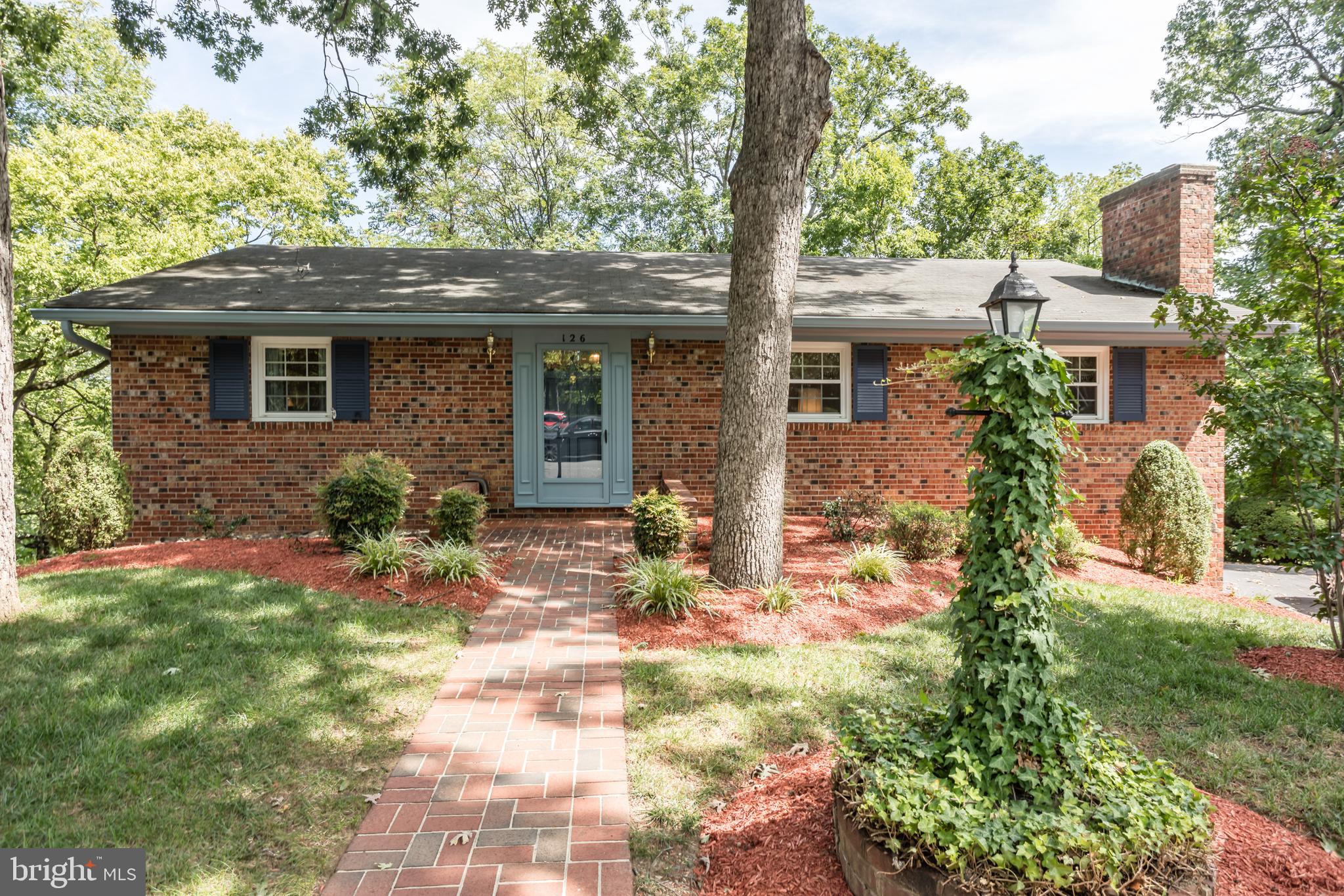 All brick ranch home with 4 bedrooms close to town and a short walk to the golf course! Main level large living Room and dinning room, 2 bedrooms and 2 bathrooms, an eat in kitchen, has gleaming hardwood flooring. Lower Level large area for pool table 2 more bedrooms, 1 bathroom and a family room equipped with a brick fireplace and space for a pool table. There is a sliding glass door that leads to a spacious deck with steps to the yard. The basement includes a shop area that could be used as storage or for hobbyists, laundry area and a third bath. There are 2 off street parking spaces. NOTE: The driveway is a shared driveway, 2/3 of the paved area belongs to this property, 1/3 belongs to the property to the right. There is space for 2 cars in the driveway.