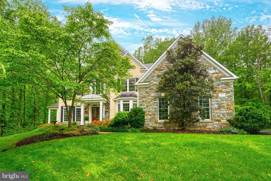 Experience the perfect blend of elegance and comfort in this stunning stone and stucco home, beautifully situated on a large, wooded lot that backs to 9-acres of undeveloped community-owned land. This property boasts exceptional curb appeal with its impressive setback from the street and mature, manicured landscaping.

The home's centerpiece is the renovated gourmet kitchen where no expense was spared! The kitchen is equipped with high-end Wolf appliances, including a gas cooktop, built-in microwave, and double wall ovens. A Sub Zero refrigerator with a paneled front complements the custom kitchen cabinetry, alongside a stainless steel farm-style sink, wood countertops, and custom shelving. The huge granite island lends itself to meal preparation as well as a place to enjoy a casual meal or cup of coffee. The spacious dining area, featuring floor-to-ceiling windows and elegant Osborne & Little wallpaper, comfortably seats 8 or more guests, making it ideal for gatherings.

The grandeur extends to the two-story great room, anchored by an expansive stone fireplace with gas logs, creating a warm and inviting focal point. In addition to both formal dining and living rooms, the main level also boasts a butler's pantry, an office with built-ins, and a light-filled sunroom with windows on all sides. 

Upstairs, the freshly painted primary suite has tons of windows, a renovated bath, and two huge walk-in closets. Three additional bedrooms and two additional full baths complete the upper level and offer enough room for the whole family.

The lower level of the home is finished with a newly renovated full bath and new paint and carpet throughout. This level provides versatile space for multiple offices, a workout room, a craft room, a TV room, a gaming area, as well as a copious amount of storage.

Outside, the private, oversized deck offers a serene retreat overlooking the protected wooded vista, ideal for relaxing and entertaining.

This exquisite home merges privacy, luxury, and functionality, making it an unparalleled offering in sought-after Vienna, VA. It is a perfect home for those seeking sophisticated comfort in prestigious Fairfax County and within 10 minutes of Reston Town Center, 15 minutes of Dulles Airport, and 30 minutes of Washington D.C.