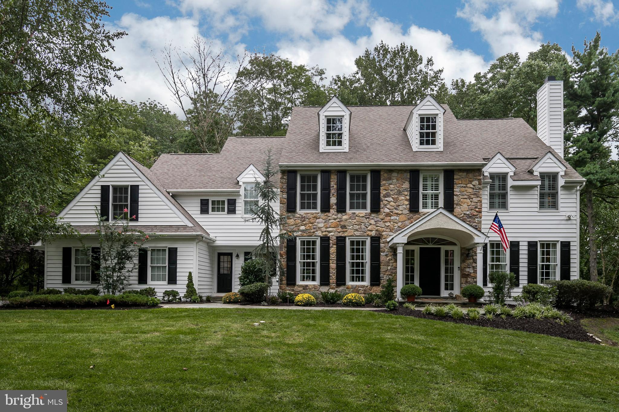 Stately stone home with incredibly low taxes in a most desirable private setting. You will immediately be wowed by the dramatic approach to this home, with its impeccably maintained grounds and property. The entire exterior has been upgraded with new insulated siding, and features a stately flagstone walkway leading to the double wide side transoms and welcoming front entrance. The value is apparent immediately as you notice the quality in all new insulated siding with a new Trex deck out back. You will also notice the fact that this beautiful property has no stucco on the exterior. Upon entering this home, you will be even more impressed by the completely updated interior, modernized floor plan featuring open floor plan, oversized doorways, and current architectural details. The interior of this home boasts a traditional, center hall colonial floor plan, with brand new hardwood floors throughout the entire first floor, and a grand foyer and staircase. As your eye is drawn to the right, you will find the stunning formal living room with fireplace, then to your left you will find the formal dining room with upgraded millwork. French doors from the living room lead to the stately office with amazing views of the property, and sliding glass doors which allow you to enjoy a private side porch. The family room provides a grand setting, thanks to its cathedral ceilings, cozy fireplace and beautiful millwork. It s floor to ceiling windows overlook a breathtaking view of the back yard, manicured landscaping, and mature trees.The open floor plan continues into the Chef s kitchen with Wolf and sub-zero appliances, double ovens, and large island counter with seating and bar area. Custom cabinetry, neutral travertine counter tops, additional refrigerator, and high end built-ins also make this area very special. The breakfast area offers plenty of room for a generous table and chairs, and is situated next to glass doors which lead out to the new Trex deck. Off of the kitchen is the mudroom, and laundry room, connected to the attached 3 car garage. For someone looking for a perfectly planned living space, this house checks all of the boxes! Upstairs, the master bedroom features vaulted ceilings, extra large master closets, and dressing area. Details in the spacious master bath include marble floors, double sinks, storage, Jacuzzi tub and marble shower. Second,third, and fourth bedrooms have large closets, and the hall bath is large enough for family and guests. The fifth bedroom is perfect for in-laws or au-pair: nestled on the opposite side of home from the master, this room can accommodate bed, office and leisure furniture with en suite full bathroom. One of this home s most impressive features is the fully finished, walk out full daylight lower level. The lower level offers a huge array of amenities to begin with, there is a full family/TV area with surround sound, complete bar with seating, work out/gym room and full bathroom. Next, there are 2 large storage areas with built in cabinetry for ample storage. Finally, the lower level walks out onto the flat level yard, surrounded by mature trees which provide this back yard with complete privacy and a sense of serenity that is very difficult to find in such a convenient location. This location is 4 miles from the center of Bryn Mawr. 3.8 miles to the center of Wayne, 1.7 miles to the new Whole Foods market and shopping center, and 26 minutes to the Philadelphia airport! Who says you can't have it all!?