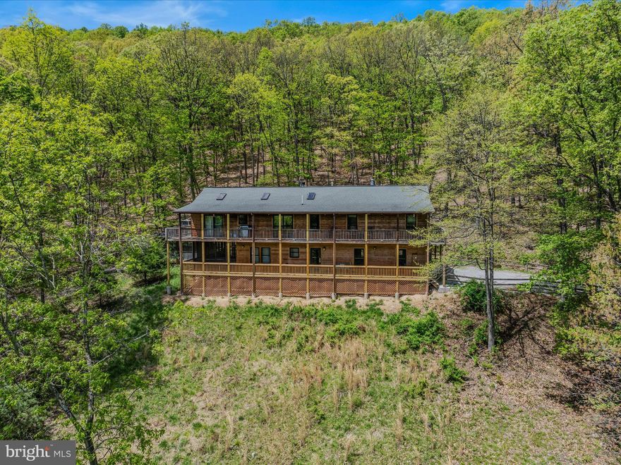 **PRICE IMPROVEMENT**  Call today to see this beautifully maintained luxurious cabin on 9.55 wooded acres  in the Appalachian Mountains. The architect designed and built this home with attention to functionality and details like Pella brand windows and doors and to take advantage of the gorgeous mountain views. You will appreciate the natural design elements, such as the pine walls/ceilings, combined with luxurious features, such as heated tile floors and a Bose speaker system throughout the home. On the main floor are 2 large bedrooms, each featuring a large closet, an ensuite bathroom and sliding glass door that lead to the screened-in porch. This spacious outdoor area brings the comforts of the indoors to the outside and you will find a large hot tub for relaxing in its own screened-in spa area. The foyer has storage, the washer and dryer, and access to the attached oversized 2 car garage. The second floor boasts an expansive open floor plan with cathedral pine ceilings and wood floors. Your attention is immediately drawn to the gorgeous stone fireplace with a large wood mantle. Natural light flows in from the large skylights, many windows and several sliding glass doors. You will find stainless steel appliances, including a new refrigerator, a gas stove, quartz countertops and track lighting in the kitchen. The cathedral pine ceiling continues into the enormous primary bedroom with a large walk-in closet and a second beautiful stone fireplace. The primary bathroom offers a large walk in shower with 2 shower heads and double vanity. Covered decks wrap around the home where you can sit and enjoy the serenity, watch for the wildlife roaming about, and relax in the fresh mountain air. Whether you call this your forever home or weekend get-away, you won't have to worry about how to stay connected because this home offers high speed fiber optic internet! Looking for that get-away that doubles as an investment? This property is currently a successful AirBnB and is a turnkey investment since most furnishings convey. Additionally, there is a new HVAC system. 

You are only about a half hour from the Lost River State Park where you can enjoy a day of guided horseback rides, hiking, swimming,  or mountain biking. Lost River State Park is a beautiful place for nature lovers to enjoy and with almost 4,000 acres it offers many outdoor recreational opportunities. Baker is about an hour from WV/VA tourists hot spots such as Bryce Resort, Black Water Falls and Canaan Valley. It is also about an hour from shopping, dining and vineyards. You are only 15 minutes from Corridor H, a little over an hour from I-81 and less than 2 hours from Dulles Airport.