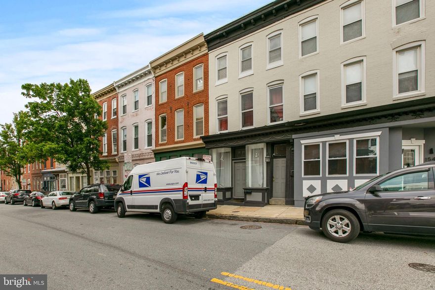 FEDERAL HILL INVESTMENT OPPORTUNITY! 1ST Floor commercial space (previously beauty salon). 2nd & 3rd floor 2 bed apt currently occupied by long term tenant. Bottom floor rental completely renovated and stunning $1550, upstairs unit $1800 . Structure extends full length of lot (16x80). Great income producing commercial property or large residential space.   Bring a roommate onboard to live in the second bedroom unit and you'll basically be living in your new home for free. Amazing location just 5 blocks from Cross Street and all the conveniences you could possibly need steps away!