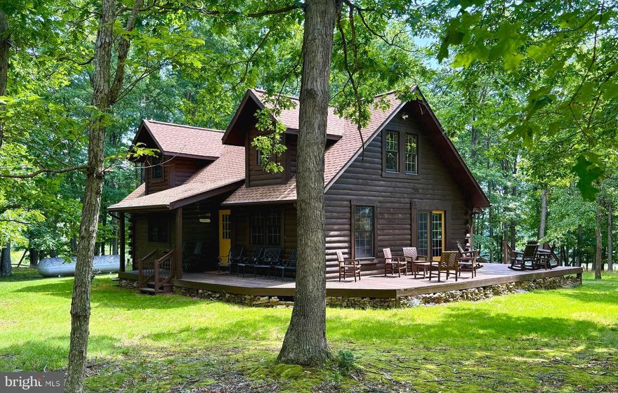 Imagine waking up to the serene beauty of nature, surrounded by the comforts of a meticulously designed mountain home. The LAZY BEAR at DOLLY SODS is  (approx) 1440 finished  sq. ft., three-story retreat and is your gateway to a life of tranquility and adventure.  23+ acres to roam, hike and splash in the creek that is located within the acreage.  

As you step inside, you're greeted by a harmonious blend of rustic charm and modern elegance. The heart of this home is the exquisite kitchen, featuring warm honey-colored cabinetry that exudes a welcoming glow. Luxurious granite countertops provide ample space for culinary creativity, while state-of-the-art stainless steel appliances ensure convenience in your gourmet endeavors.

The living areas are a testament to comfort and style. A magnificent stone wood burning/electric fireplace serves as the focal point, inviting you to cozy up on chilly evenings. Large windows frame picturesque views of the surrounding forest, bringing the outdoors in and filling the space with natural light.  A oversized primary ensuite with bath complete this level.   A door from the primary suite leads directly to the hot tub for a little soaking under the stars.

Upstairs, a loft area offers versatility - perfect for a home office, reading nook, or additional living space. The bedrooms are sanctuaries of relaxation.

Thoughtful details abound throughout the home. Wooden accents and exposed beams add character and warmth, while modern fixtures provide contemporary flair. The bathrooms blend functionality with style, featuring elegant vanities and ample storage.

This property isn't just a house; it's an invitation to a lifestyle. Imagine entertaining friends on summer evenings, hiking through nearby trails, or simply enjoying the peace of your private woodland retreat.  New Roof, Gutters & Gutter Guard installed in 2022.  Here, at 230 Polar Bear Rd, your dreams of mountain living become a reality. Welcome home to your personal slice of paradise.

An active short term rental property-here's your chance to a turn key business.  Dolly Sods is close by.  Seneca Rocks, Vepco Lake, Spruce Knob, North Fork of the Potomac River & Monongahela National Forest within a short drive for many outdoor adventures.
