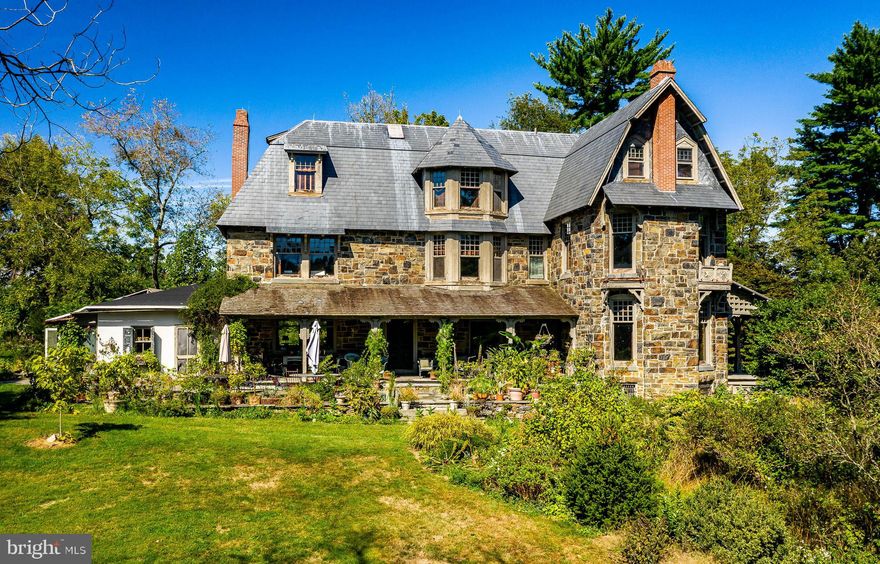 The approach to the wonderful Happy Hill estate is down a long, private road, past stone retaining walls on one side and glimpses on the other of Craigs Mill Run, a tributary of the Brandywine Creek. The driveway of this 8.9-acre Chadds Ford farm offers pastoral views of a stunning English garden landscape replete with Pennsylvania state champion trees including a Yellow Buckeye, Cucumber Magnolia, and a Nordmann Fir. The final approach to the Manor House is past fields, woodlands, and a stone bank barn. Simply idyllic. The stately home, built in several stages in the mid to late 1800s to expand  a pre-Revolutionary homestead, features an entry Foyer with a spectacular hand-crafted solid walnut turned staircase that ascends three stories. Off the Foyer is a large Living Room with a museum-quality fireplace mantel flanked by two south-facing windows with stained glass panels above. Many of the home’s windows are impressively large for a home of this vintage and all have pocket shutters. Across the Foyer from the Living Room is the Dining Room, accessed through pocket doors, which also features another museum-quality fireplace mantel. All of the home’s wonderful trim, woodworking, and moldings are crafted from walnut. The rooms on the main level access one of three covered porches. The Study is a gracious room that adjoins the Living Room through a wet bar and accesses two covered porches. The Family Room has a beautifully crafted walnut bookcase next to a fireplace. Off the Family Room is a back staircase to the Upper Level as well as a staircase to the basement. Next is the Kitchen featuring exposed beams and high-end commercial appliances. The second level features two large family bedrooms plus a large Master Suite which encompasses two rooms, one is the large bedroom which occupies the same space as the Living Room below and features handsome custom walnut cabinetry, a fireplace, and large windows. Across the Hallway is a modern Bathroom and a large room which also features custom walnut cabinetry and a fireplace. This particular space could easily become a fabulous large closet or home office. Two additional bedrooms are on this level, each offering large windows with stellar views of the estate’s gardens, fields and woodlands. The main staircase ascends to the third level which houses three additional bedrooms, all with high ceilings and large windows. There is also a spacious attic which could become additional living space if desired. Outside is a large bank barn that needs some attention plus a stone structure that pre-dates the home. This structure and the original part of the house sheltered Hessian soldiers during the nearby Battle of the Brandywine. An in-ground, slate blue pool constructed in 2003 offers quiet swimming, a panorama of the neighboring fields, and a stately perspective of the Manor House. This incredible property, named Happy Hill by a previous owner, is set in an absolutely priceless location! The property is a true “diamond in the rough” as work is required to return this property to its glorious past. Because of its phenomenal location, property assets, the home’s priceless appointments, and the tremendous “great bones” of this fabulous stone home, any investment a buyer makes will be repaid. Located in sought after Chadds Ford and in the heart of Wyeth country, and surrounded by open, protected land, yet close to Rt. 1, Wilmington, and the Philadelphia airport, this property is also in the nationally ranked Unionville-Chadds Ford School District. This is a great opportunity to create an unparalleled country estate, with huge potential upside. This could truly become your “Happy Hill”!