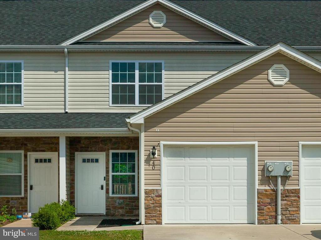Modern town house offers fresh paint throughout in tasteful colors. The main level features an open floor with easy to maintain laminate flooring and draws you in with a warm welcome as you step through the front door and into the living room. Easy flow to the eating area and kitchen with granite counter tops, dark cabinetry, and black appliance package. Walk-in pantry, half bathroom, and convenient garage access from the living area completes the lower level. Upper level features laminate flooring throughout and vaulted ceilings in the bedrooms. Master bedroom suite offers private bath and large closet. Two additional bedrooms, full hall bathroom, and convenient laundry closet finish the upper level. Rear yard is fenced with patio for entertaining and outside play. Convenient home package is located just minutes from i-81 and Virginia.