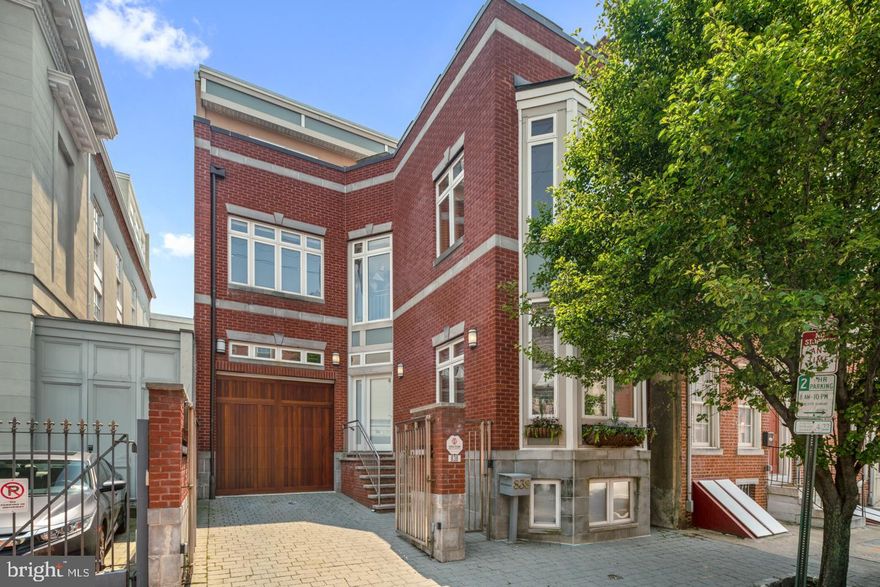 Offering 3,500+ square feet over a double wide lot, this exciting Washington Square West residence is a contemporary classic. A timeless brick facade and massive bay windows welcome you home through a gated front courtyard & garage parking. Inside, expansive windows, a spacious floor plan, and gleaming wood floors brighten the space throughout. Situated around a dramatic central staircase and adjacent elevator, the lower levels feature a fully renovated Chef's kitchen, breakfast bar, living & dining areas, generous back patio, and a finished en-suite basement ideal for an in-law suite, au-pair suite, or media room. Upstairs, a sunny & serene rear-facing Master Suite includes a large walk-in closet, private balcony and bath with double vanities, rain shower and jacuzzi tub. Second floor also has a home gym and an office/nursery. On the third level, find 3 additional bedrooms, 2 full baths and access your over-sized rooftop terrace for gorgeous City views. Meticulously maintained, the property is equipped with dual zone HVAC, upgraded systems and 2-car parking. Perfectly located just steps to an unparalleled restaurant scene, Italian Market, grocers (Whole Foods and Acme), (3) parks (within 2 block radius), cafes, and all the diverse arts & culture of Washington Square West. Schedule your appointment to view this remarkable home today!