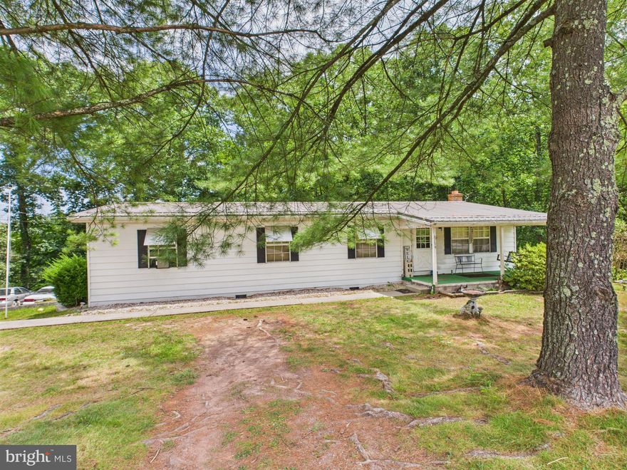 This 2-bedroom (once 3), 2-bathroom ranch-style home offers a solid investment opportunity with a spacious 1.75-acre lot. Built in 1973, the property features a traditional floor plan with a galley kitchen, eat-in area, and a cozy dining space. Interior highlights include carpet and laminate flooring, a primary bath with tub shower, and a walk-in closet. The home is partially furnished and equipped with essential appliances, including stainless steel options. The exterior boasts a deck, porch, and secure storage shed, complemented by block retaining walls and a play area with a large side yard. Enjoy serene views of the wooded surroundings, enhancing the property's appeal. With ample parking, including an oversized rear garage and driveway space for up to 8 vehicles, this property is not in a development, offering unrestricted use. The potential for rental income or future appreciation makes this a compelling choice for investors seeking value in a tranquil setting.