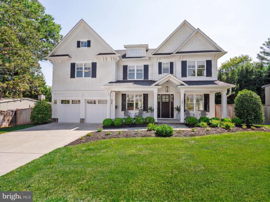 7607 Hemlock Street | Bethesda, MD 20817

Some homes are built to impress. This one was built to live in — and the difference shows in every detail.

Set on a quiet street in Oakwood Knolls, one of Bethesda's most coveted neighborhoods, 7607 Hemlock is a custom-crafted residence where thoughtful design meets the rhythms of real family life. Highly ranked Walt Whitman High School and Pyle Middle School are an easy walk away; Burning Tree Elementary is a two-minute drive. For families who've made the school district a priority, the location alone is the story.

The home's flagstone porch and striking architecture announce what's inside: over 6,000 square feet of light-filled, intelligently designed living space. The main level opens with a gracious center hall foyer leading to soaring ceilings, rich oak floors, and a seamless flow between formal and informal spaces — crown and wainscoting moldings, coffered and tray ceilings, and high-end hardware throughout. The formal living and dining rooms give way to a fully appointed entertainer's bar with beverage center, sized for the kind of hosting that doesn't require apology.

At the heart of the home, the gourmet kitchen was designed for people who actually cook. A massive center island anchors the space, flanked by quartz countertops, a large walk-in pantry, and professional-grade Thermador appliances — a six-burner gas range with built-in griddle, double wall ovens, and an oversized side-by-side refrigerator. Discreet under-cabinet electrical outlets keep the counters clean. The adjacent family room, with its wall of windows, custom cabinetry, and gas fireplace framed for a large-screen TV, is where the day ends.

When the weather cooperates — and even when it doesn't — a full-width NanaWall opens the kitchen directly onto a large screened-in porch, collapsing the boundary between inside and out. The backyard has been fully re-graded and transformed: a new stone patio, lush landscaping, and a perimeter of Chindo viburnums sourced from a North Carolina family nursery. Already deeply rooted, these pet-safe, low-maintenance evergreens will reach approximately 16 feet, delivering a private canopy without encroaching on the yard itself.

A dedicated main-level study, powder room, and a mudroom with built-in cubbies round out a floor plan that anticipates how families actually move through a day.

Upstairs, the primary suite is a proper retreat: private foyer entry, tray ceilings, two large walk-in closets with custom built-ins, and a spa bath with an oversized shower and dual vanities with custom mirrors and sconces. Three additional bedrooms — each generously sized — share two full baths, while a separate upper-level living space serves naturally as a study zone, playroom, or secondary family room. A spacious laundry room with extensive cabinetry and large-capacity machines is where it should be: on the bedroom level.

The fully finished lower level adds meaningful square footage without feeling like an afterthought. A recreation room with wet bar, a private theater room, a rubber-floored exercise room, and a bedroom suite with full bath and walk-in closet together create a floor that functions as a destination, not just overflow space. The two-car garage has been fitted with overhead storage racks — a small detail that matters when you're actually using it.

Oakwood Knolls puts downtown Bethesda, Chevy Chase, and Tysons Corner within easy reach, with straightforward access to DC and three major airports. For a family ready to stop compromising between location, schools, and the home itself — it's hard to imagine doing better than this.