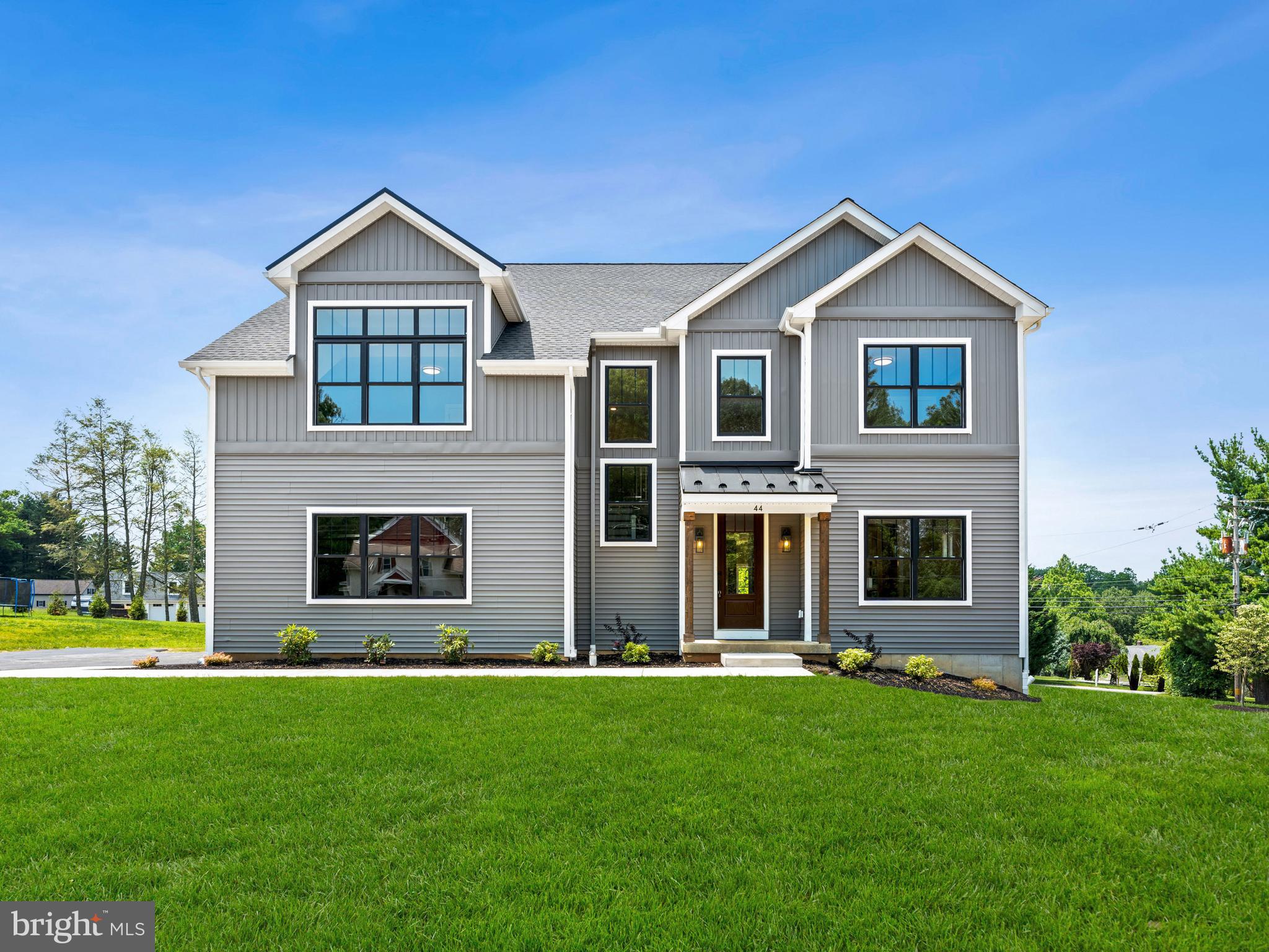 Presenting a rare opportunity to own the finest residence on the premium corner lot in the prestigious community of Middletown Twp. This custom-built farm/Hs, located on Lot 1, is the pinnacle of refined design & craftsmanship. We are proud to offer this stunning new construction, meticulously crafted to deliver the highest standard of lux/living. W/only 2 homes remaining in this exclusive enclave, this corner lot stands as the crown jewel of the entire dvpmt. Upon entering through a grand 8-ft door, you are immediately embraced by an atmosphere of exceptional style & sophistication. The expansive foyer, graced with 6.5-inch engineered HW flrs that extend T/O the home, sets the tone for the elegance found W/I. Every detail of this residence has been thoughtfully curated, showcasing the ultimate in modern liv & classic charm. The 9-ft ceilings on the 1st flr enhance the spaciousness, while the thoughtfully designed 2-car gar offers direct access to the interior. Situated on a coveted corner lot, this home boasts a PR/Dr that can accommodate over 5 vehicles, ensuring that you & your guests enjoy unparalleled convenience. Inside, the beautifully designed P/Rm, featuring brass fixtures & quartz C/Tops, exudes a touch of refinement. The PR/ office offers a quiet, dedicated space ideal for work or study. The lrg, open-concept F/Rm is complemented by a gas F/PL & flows seamlessly into the gourmet kitch—a true chef's paradise.The kitch is equipped with top-of-the-line Jenn-Air S.S app, including a gas cooktop & wall oven, along w/ custom cabinetry by Goebelwood Industries adorned w/ brass HW. The butler’s pantry & walk-in pantry provide add/storage & functionality, making this space perfect for both casual family meals & elaborate dinner parties in the D/Rm, highlighted by stunning light fixtures that elevate the home’s timeless appeal. Expansive windows & 3 sliding glass doors fill the home with natural light, creating a bright, airy ambiance. These doors lead to a covered rear porch that invites seamless indoor-outdoor living, offering the perfect setting for al fresco dining & relaxation amid lush surroundings. The 2nd FLR is home to 3 spacious B/Rms , each thoughtfully designed to provide comfort & tranquility. The luxurious master suite is a true retreat, featuring tall tray ceilings & a custom-designed bathroom with a spa-inspired glass-enclosed shower, a freestanding soaking tub, & bespoke cabinetry. A W/I custom closet adds a touch of luxury, and pull-down stairs lead to additional storage. For added flexibility, the full un/bsmt includes two egress windows, offering limitless possibilities for expansion—whether it’s additional living space or an entertainment area.This home’s commanding curb appeal is enhanced by its premium corner lot, with a stunning exterior featuring board-&-batten farmhouse vinyl siding and durable 30-year GAF Timberline HDZ shingles. Designed with the utmost attention to detail, this residence is built to the highest standards of energy efficiency, with Harvey fiberglass wind and R-21 batt insulation ensuring year-round comfort & sustainability. We are thrilled to present this unparalleled residence in one of the most desirable locations in Middletown Twp. The premium corner lot offers both privacy & exceptional views, making it the best lot in the development. W/ its prime location, superior craftsmanship, & luxurious features, this home represents the ultimate in refined living. Conveniently located near major transp hubs and key amenities—Wawa Train Sta (2.1 mi), DTwn Media (2.3 mi), Phil Intern. AP (15 mi), C. City Phil (24 mi),and Riddle Hosp (0.8 mi)—this home is perfectly positioned to offer both serenity & accessibility. This is more than just a home; it is an extraordinary opportunity to experience the pinnacle of lux/living on the most coveted lot in the community. Don’t miss your chance to own this exceptional property your dream home awaits!