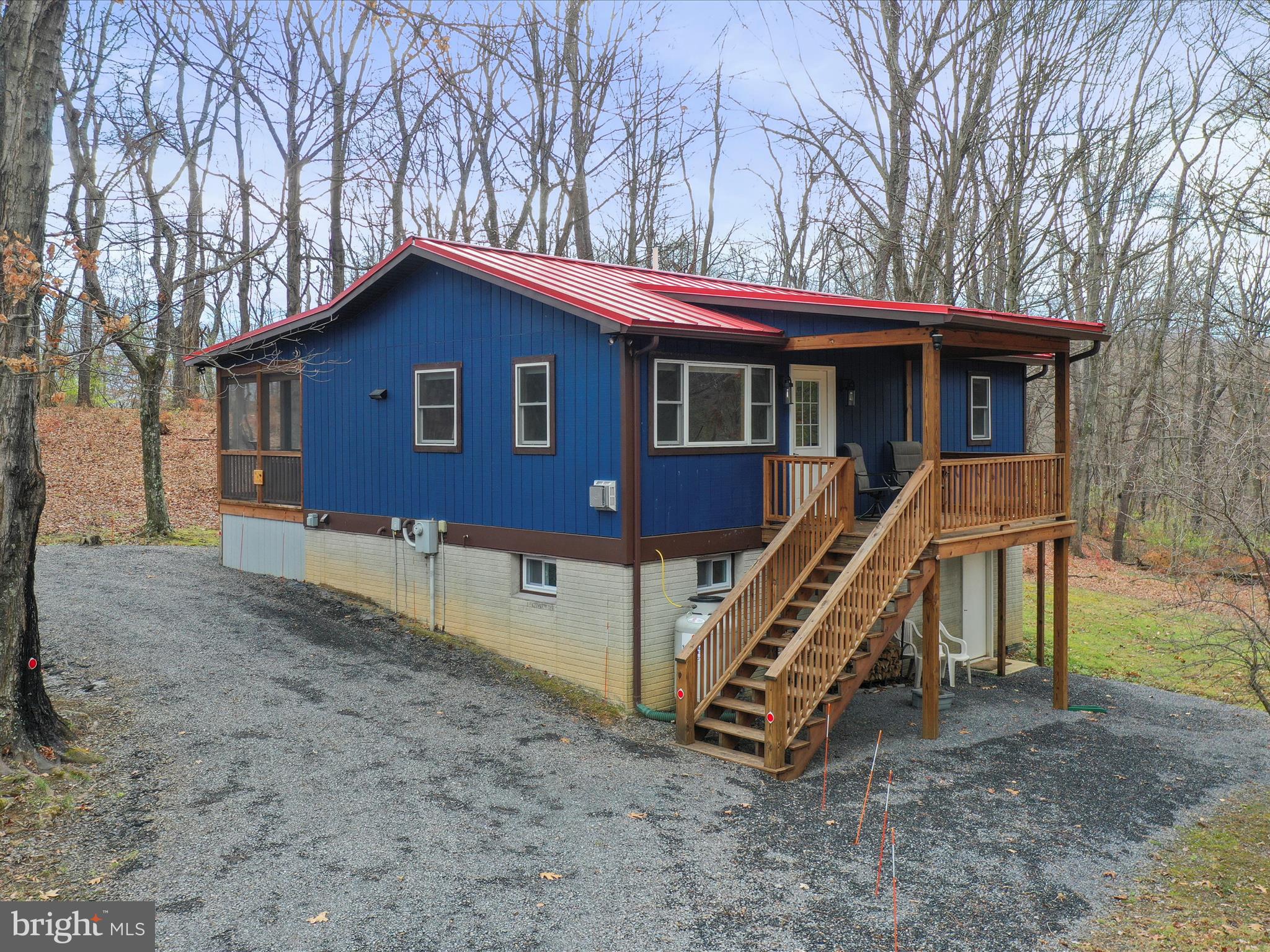 Discover this beautifully renovated modern cabin, nestled in West Virginia's scenic charm. Thoughtfully designed for relaxation and practicality, this home features an open, light-filled layout that invites you to unwind. The living area features a charming stove, perfect for cozy evenings. The kitchen combines style and function with sleek stainless steel appliances, granite countertops, and carefully chosen tile details.
The primary bedroom offers breathtaking mountain views right from the window and includes a private ensuite bath. A second bedroom and adjacent full bath provide added comfort and convenience. Downstairs has been transformed into a versatile den, game room, or TV space with a laundry space, while the other half offers abundant storage and room for hobbies.
Step outside to the screened-in deck, where you can enjoy West Virginia’s changing seasons. This outdoor space is perfect for sipping morning coffee, grilling, or dining al fresco. A circular driveway ensures easy access, and thoughtful touches like an electric car charging station, or a fire pit to gather with friends, and a perfectly placed bench to soak in the views make this property truly special.
The home is as practical as it is beautiful, featuring an updated water treatment system, a durable metal roof, and fiber-optic internet for seamless connectivity. Currently an active short-term rental, this property offers the unique opportunity to be purchased fully furnished, making it an effortless investment or a ready-to-enjoy retreat.
All of this is just two hours from DC but feels like a world away. Nestled just outside George Washington National Forest and the Trout Pond Recreation Area, you’ll find endless opportunities for outdoor adventures, from swimming and kayaking to fishing. For shopping and dining, both Wardensville and Mathias are conveniently located just 20 minutes away in either direction.
Don’t miss your chance to experience this modern mountain getaway. Schedule your showing today!