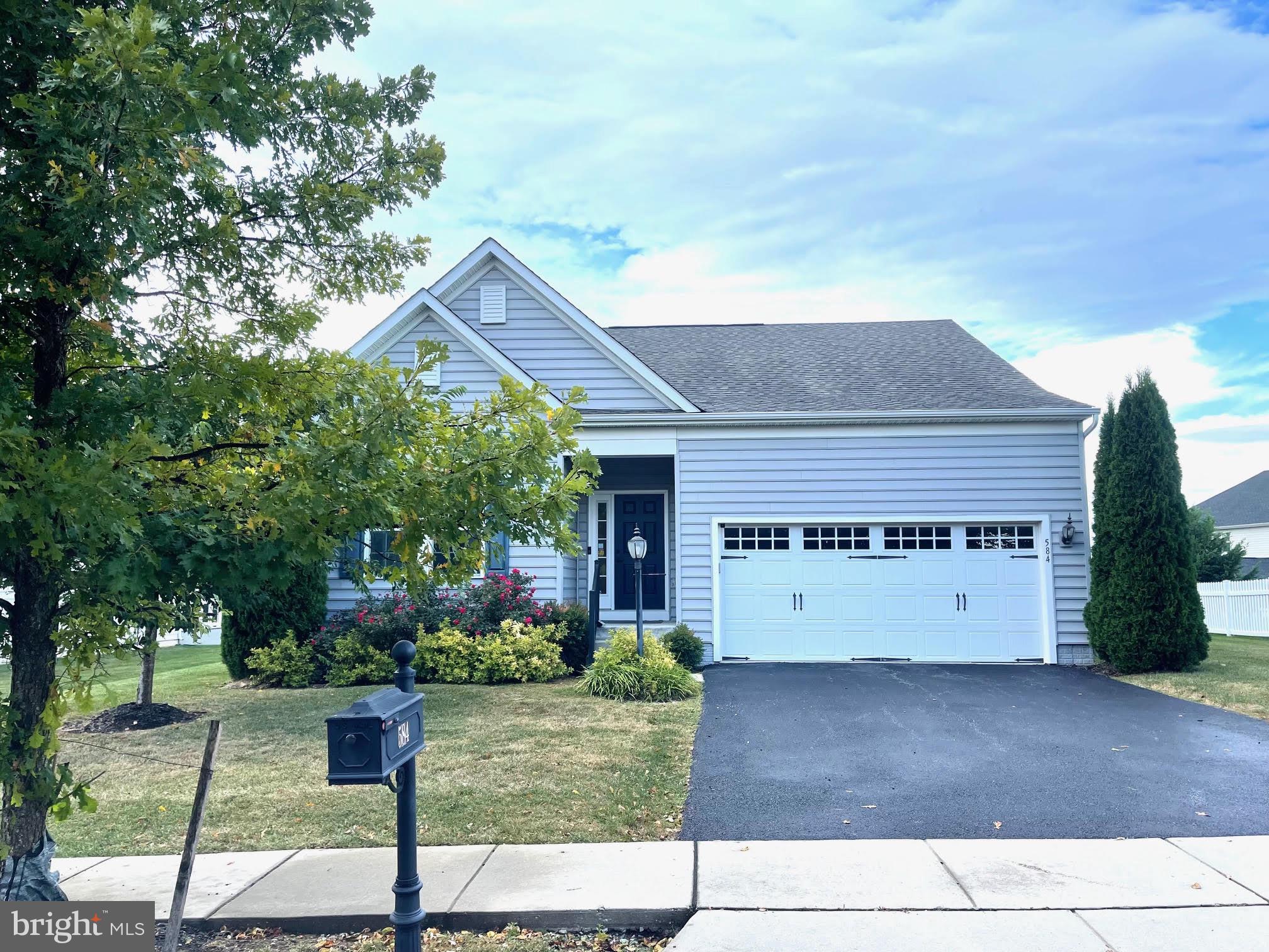 Easy one floor living in this 2 bed 3 bath 2 car attached garage ranch style home built in 2017. Stylish modern lighting and open concept layout is designed for both everyday living and entertaining. This home offers a perfect blend of comfort and modern convenience. Step inside to an inviting floor plan with dark rich hardwood floors through the main living area. As you walk in the front door into the foyer, you are greeted with 9 ft ceilings and a crystal glass chandelier with tray ceiling giving you a sense of elegance. Off to the left you will find the hall bathroom adjacent to the 1st bedroom. Making your way down the hallway from the foyer you will enjoy a private office space with glass french doors. As you continue to the large open kitchen, dining, and living space you will discover an over sized island with beautiful quartz countertops and a deep stainless steel sink , 42 inch modern cabinets accented with a contemporary tile backsplash along with stainless steel appliances and recess lighting. Step outside off the kitchen onto your covered composite deck that looks over your fantastic fenced in yard which is ideal for enjoying a morning coffee or evening outside dining. Just off the living room is the primary quarters spa bath on suite. With a Roman stand up shower, Large tile bath for 2 separate areas to shower with shower bench, you will feel like you are in a luxurious hotel room. Primary bedroom also has a custom walk in closet with drawers and hanging areas for your entire wardrobe. Additional highlights include: tankless water heater for on-demand hot water anytime, 3 brand new ceiling fans with remotes, and a finished basement area perfect for a flex space, gaming, workout, or an extra family room. There is also large storage area at the bottom of the stairs to your right that could easily be turned into a spare bedroom. Enjoy Logan's Reserve community amenities with low HOA fee that include; clubhouse, swimming pool, playground, walking path, workout facilities, gathering room & basketball court. Only a short distance to Maryland, access to I 83 North and South, Make your appointment to see 584 W Ore St. before it's gone. Sale is as is. Seller has moved to Florida.