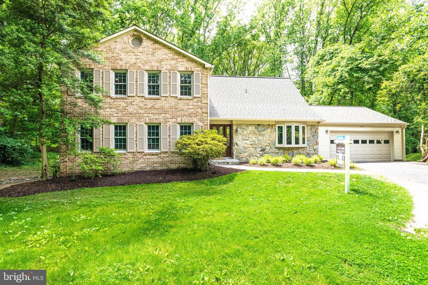 Gorgeous, renovated, open concept colonial in highly sought-after Wolf Trap Woods -- feeding into Langley High School & backing to Wolf Trap National Park for the Performing Arts! Hardwoods throughout main level! All renovated baths! STUNNING kitchen with stainless steel appliances, large island, on-trend pendent lighting & beautiful views of your backyard and trees! Kitchen opens to large family room with brick wood-burning fireplace w/ mantel, surrounded by built-in shelving/cabinets. French doors from family room lead you to fabulous screened porch with access to additional deck, perfect for grilling, and stairs down to patio! Over-sized formal powder room on main level.  Tons of living space with spacious great room, separate dining room and  living room.  Expansive owner's suite with sitting room, walk-in closet with additional storage, separate tub & shower & water closet. Upper level offers 3 additional bedrooms with ample closet space! Upstairs hall bath offers granite countertops, on-trend lighting and tiled tub/shower with glass doors! Lower level offers recreation room, 5th bedroom, updated full bathroom and bonus room! Walk out to your private back patio and fenced yard!  Two heating/cooling zones! You CAN'T beat the LOCATION!  Surrounded by peaceful/tranquil woods & trails, yet minutes to Tysons & the explosive growth of The Boro! …offering theaters, restaurants, Whole Foods, Wegman’s!, Starbucks & more! Wolf Trap Woods has miles of walking/running trails, and Wolf Trap is open year-round for concerts, hiking & picnics!  Easy access to Rt. 7, 267 (Toll Road), 66 & 495.  Approx. 2 miles to the Spring Hill metro stations (Tysons Silver Live) via lighted walking/bike trails (soon to be completed) and just 10 minutes to downtown Vienna, McLean, Reston Town Center & the Village of Great Falls! Spring Hill Elementary, Longfellow Middle & Langley High School.  Roof is 2011 architectural shingles.