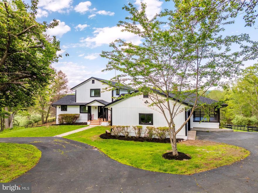 OPEN HOUSE SATURDAY 5-16-2026 FROM 2PM-5PM! Nestled in the serene landscapes of Marshall, VA, this exquisite contemporary residence, set on an expansive 8.3-acre lot, offers a luxurious lifestyle defined by elegance and tranquility. The property has undergone a major renovation in 2026, ensuring modern sophistication while preserving its timeless charm. The exterior features a stunning wood siding façade, harmonizing beautifully with the natural surroundings. A circular paved driveway leads to an oversized attached garage, providing ample parking for guests. The property boasts a dedicated barn/stable, catering to equestrian enthusiasts, while the lush, private grounds are bordered by trees and open space, creating a secluded retreat. Step outside to revel in breathtaking panoramic views of the mountains and valleys, where every sunrise and sunset paints a picturesque backdrop. The meticulously landscaped rear yard invites outdoor gatherings, while the surrounding wooded areas offer a sense of peace and privacy. Inside, the home features four spacious bedrooms and three and a half luxurious bathrooms, complemented by two elegant wood-burning fireplaces that add warmth and character. The fully finished daylight basement provides additional living space, perfect for entertaining or relaxation. This property is not just a home; it's a lifestyle, offering the perfect blend of luxury, nature, and equestrian amenities. Experience the ultimate in refined living, where every detail has been thoughtfully curated for comfort and style.