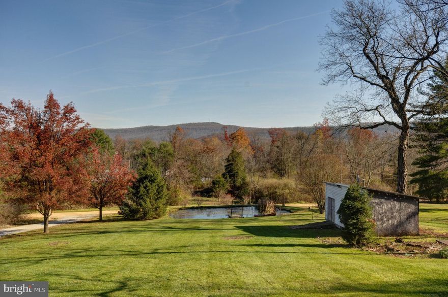 Really nice home located  in Golden Acres just minutes from Route 50.  Home features 4 bedrooms, 2 baths,  Primary Bedroom has an addition room that could be used as a Den, Office or perfect for a Nursery. 
2200 sq. ft. double wide in good condition detached two car garage.  Approximately 35 minutes from Winchester makes this home a great commuter location.  Large open rooms gives you all the space you need for a growing family.   Amazing views of the mountains and your own pond.  This beautiful home has so much to offer.   There  are two additional lots  included in the acreage.  
Parcels included in the sale are 10A 41, 10A 42