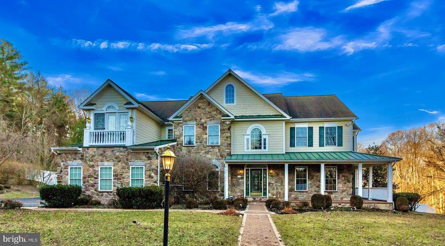 Beautifully updated 5 bedroom 4.5 bath located on a private 2acres. Walk up to the welcoming stone front wrap around porch that leads to crystal cut doors. Walk into a 2-story foyer with new Italian marble floors flowing down into the kitchen. The formal living room provides plenty of natural light and crown molding. Easily entertain in the dining room with chair railing and center chandelier. The kitchen provides plenty of counter space, cabinet space and stainless steel appliances including new French door refrigerator with pull out freezer, dual wall over and electric cook top with hood vent. Breakfast room leads to the solarium with a heated in-ground 3’ to 9’ deep pool with all new plumbing, new filter that can be either chlorine or salt water and new heater. Solarium also has a New mini split air-conditioner. Vaulted ceiling Great Room with hardwood floors, gas fireplace, oversized crown molding and wainscoting throughout. French doors lead to a private library with built-ins and French doors leading to the outside. Retreat to the spacious primary bedroom with large sitting area, dual sided gas fireplace and walk in closet. The en-suite features double slipper soaking tub, separate glass stall shower and dual vanity . The second bedroom includes plush carpeting, window seat and private bath. The third and fourth bedrooms are spacious and include a Jack and Jill bathroom. The basement is perfect for entertaining with wet bar, fire place and an additional bedroom either perfect for guests or movie room. Enjoy summer nights on the brick patio overlooking the peaceful 2acres backing up to preservation land and the Liberty Reservoir! Walk down using the trail on the side near the gazebo. Never worry about parking in the 3 car attached garage and long driveway with extra parking pad. There is a whole house generator and gazebo features nuclear fallout shelter (sold as-is).  Updates include Vinyl Fence, Complete HVAC System (2 zones) and Furnace, Electric for a Hot Tub, and Sump Pump. All there is left to do is move in!