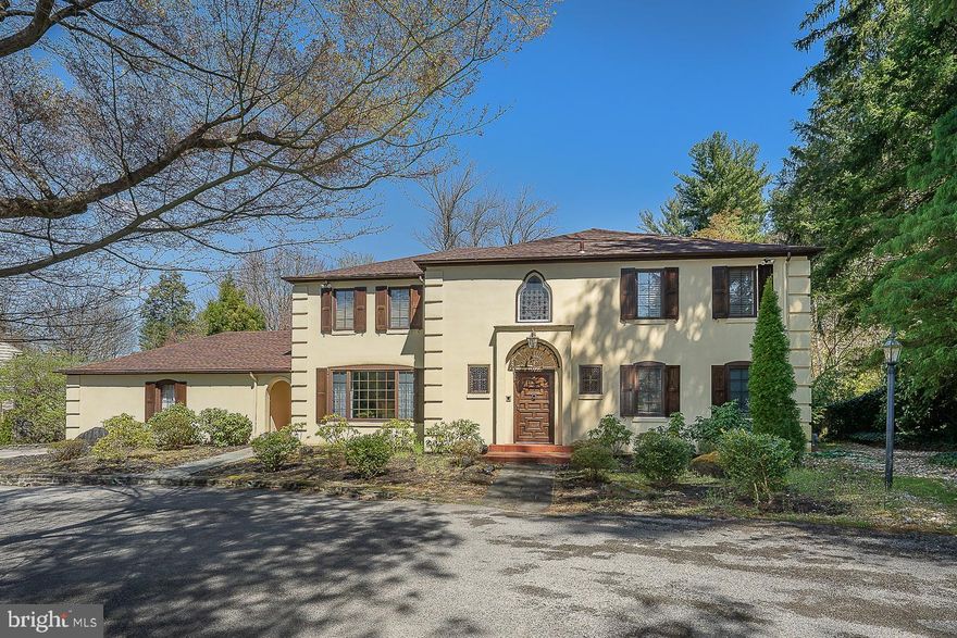 Exquisite Spanish Colonial home showcases gorgeous wood and iron details throughout with all of today’s modern amenities.  The 2-story entry has a tile floor and an open curved staircase with a beautiful wrought-iron railing that sets the stage for this 5000+ square foot, 5 bedroom, 4 full bathroom, and 3 half bathroom home situated on a beautiful, level, .83 acre lot.  Gorgeous hardwood floors and exposed beams highlight the study and family room with fireplace.  The formal dining room features crown molding and one-of-a-kind, built-in cabinets that will capture your dinner guest's attention and are located conveniently off the kitchen for easy entertaining.  The spacious, updated eat-in kitchen is a chef’s dream with an oversized island with seating offering tons of workspace, a farmhouse sink, double wall oven, Thermador gas range, and a built-in refrigerator and dishwasher.  There is also a Breakfast Area and sliders to the tranquil patio. The formal living room is both warm and elegant with its exposed beams, a fireplace with intricately detailed mantel and surround, and huge arched windows overlooking the back patio and grounds beyond.  Mudroom, laundry room, and 2 half baths complete this level.  Upstairs the large primary suite is complete with a Juliet balcony overlooking the backyard, offers tons of closet space, and two NEW primary bathrooms.  Additionally, you will find, four good-sized bedrooms, one with an ensuite bath, and all with great closet space, a full hall bathroom, and 2nd laundry area.  The finished lower level offers endless possibilities to suit your needs…a playroom, game room, or workout space and includes a half bath.  The tour does not end here, step outside to find the wonderful private outdoor entertaining space including a large slate patio with a built-in fireplace and pizza oven, heated in-ground pool with covered patio area, and a separate fire pit area.  2-Car Garage, a Generator, 2 Zone HVAC, and Newer Roof.  Located in the Award Winning Lower Merion School District.  Convenient to shopping and dining of both downtown Narberth and Ardmore and a short commute to Center City. This home is truly one of a kind.