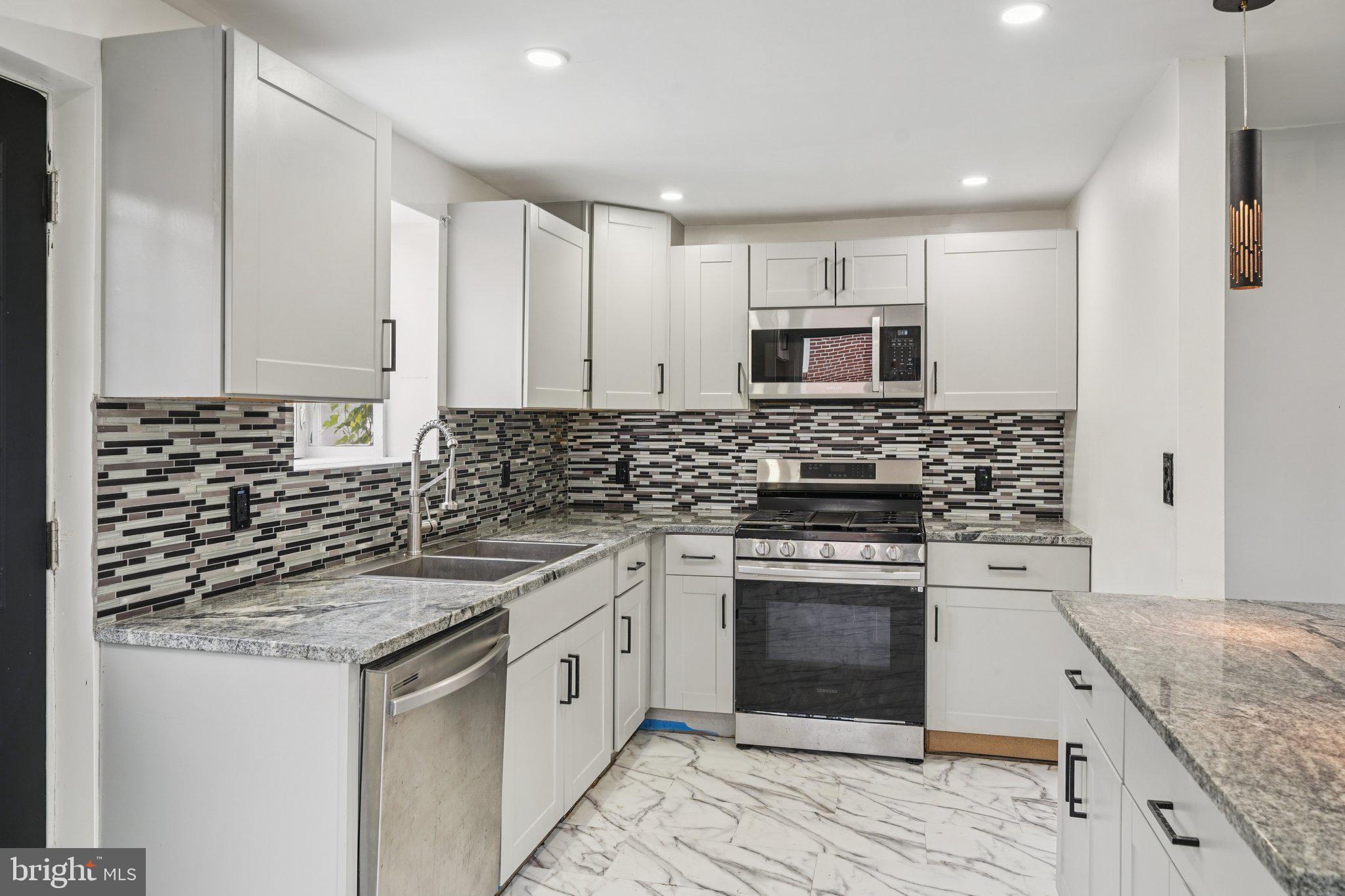 Welcome to 340 Greenwood Rd, a beautifully updated brick twin home that’s move-in ready and full of charm. This bright and open layout features a spacious main living and entertaining area with luxury vinyl flooring and recessed lighting, flowing seamlessly into the dining area and a stunning kitchen. The kitchen is equipped with gray cabinetry, a breakfast bar, custom tile backsplash, granite counters, and recessed lighting—perfect for cooking and gathering with family or friends. An updated powder room with custom tile completes the main level, and a door from the kitchen opens to the patio, backyard, and shed for outdoor enjoyment and storage. Upstairs, you’ll find three generously sized bedrooms and an updated hall bathroom with custom tile, providing comfortable space for everyone. The finished lower level adds even more versatility with a family room, recessed lighting, luxury vinyl flooring, laundry area, and storage/utility room. Parking is convenient with a driveway that accommodates 3+ vehicles. Ideally located near parks, restaurants, and public transportation, with easy access to major highways for commuting, this home combines thoughtful updates, functional spaces, and a convenient location. Don’t miss the chance to make this move-in ready gem your new home—schedule a showing today!