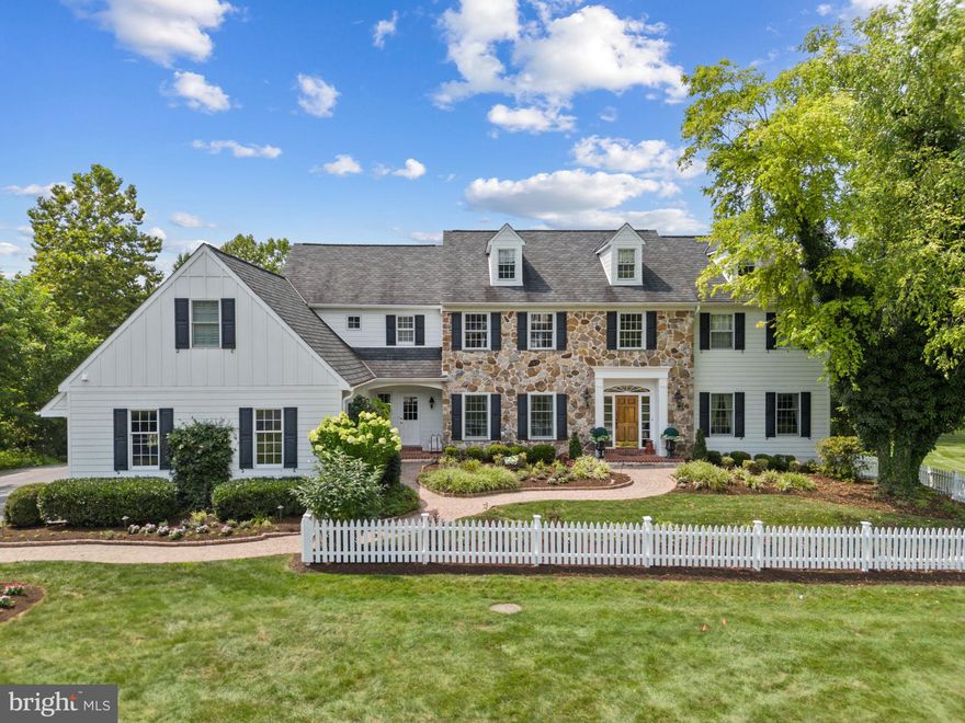 Welcome to 740 Monument Road – a stunning 4-bedroom, 4.5-bath home tucked away on a quiet private lane in desirable Willistown Township, just minutes from the heart of Malvern Borough. From the moment you arrive, the timeless stone front paired with updated HardiPlank siding sets the tone. A paver walkway leads you to the bright two-story foyer with gleaming hardwood floors that flow throughout the main level. To your right, the formal living room is anchored by a marble-surround, wood-burning fireplace with crown molding detail. To your left, the dining room is filled with natural light and finished with chair rail molding—perfect for holidays and gatherings. At the center of the home, the two-story great room impresses with a beautiful stone fireplace, custom built-ins, and a wall of windows that drench the space in sunlight and allow for a spectacular view of the weeping willows and during some seasons a view of the adjacent pond with swans! A French door open to an incredible outdoor living area, seamlessly blending indoor and outdoor entertaining. The kitchen is a dream—complete with a breakfast bar island, gas cooking, abundant cabinetry, and an oversized butler’s pantry with wine storage and sink. From here, you’ll also find easy access to the mudroom with built-in cubbies, a walk-in pantry, side entry from the driveway, and the attached 3-car garage. The outdoor living space is truly the jewel of this property: a Timbertech deck with both covered and uncovered sections, ceiling fan, built-in grill, and stone countertop and all overlooks the lush rear yard with mature trees. Whether you’re hosting friends or enjoying a quiet evening at home, this space delivers. Also on the main level is a private study with rich millwork, custom built-ins, and access to the conveniently located powder room. Upstairs, the primary suite is a true retreat. Highlights include hardwood floors, two walk-in closets, a cozy sitting area with hidden TV, and charming antique barn doors that conceal the perfect luggage storage. The spa-like en suite bath features his and hers sinks, a separate vanity area, oversized soaking tub, frameless shower, and a show-stopping floral tile accent wall. A bonus room off the suite is a spacious laundry room with sink, and still more space for an office, a craft room, or a yoga room. The second floor is completed by a junior suite plus two additional bedrooms connected by a Jack-and-Jill bath. The finished lower level adds even more living space, with a walk-out design, wet bar, full bath, private gym, and sliding doors that open to the backyard. Set on a quiet cul-de-sac, this home, on 2.1 level acres, is in the award-winning Great Valley School District and within walking distance to Malvern Borough shops, restaurants, and the train station. Please note this property has a BRAND-NEW septic system - installed summer 2025 - and has a generator. Don’t miss the opportunity to call this incredible property home—schedule your private tour today.