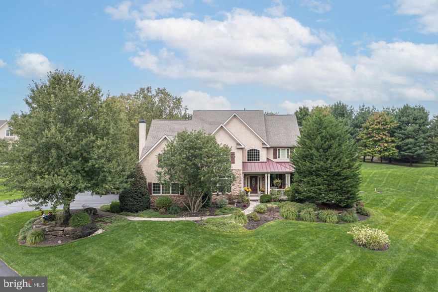 This gorgeous custom-built home has so much to offer and is located amongst an incomparable setting. Offered for the first time is this beautiful home that highlights wonderful natural light, great space and a neutral palette. Step inside from the quaint porch and take notice of the beautiful finished in place hardwood floors and custom millwork.  The formal living room is a quiet respite and flows into the elegant dining room with custom built-ins and tray ceiling. The expanded kitchen makes hosting guests a breeze, with a beautiful center island with a prep sink and additional seating, stainless steel appliances, a separate refrigerator and freezer, and a gorgeous tile backsplash. A lovely open layout continues, connecting the light-filled breakfast area to a spacious gathering room, complete with a cozy gas fireplace, a door leading out to the back patio, and a convenient back staircase. Working from home will be a dream in a bright main level Study featuring large windows, detailed millwork, custom built-ins, large closet and connected to a full bath. Upstairs one will find 4 spacious bedrooms including the Main Suite with tray ceiling. The walk-up lower level provides additional living space and features a bar area, entertainment space and a bonus room with a full bath. Additional amenities include an oversized mudroom with built-in cubbies, generator, recessed lighting, ceiling fans in all bedrooms, a laundry chute, fantastic storage and a 2+ car garage. All of this on a picturesque, almost 1.5 acre lot with paver patio enveloped by blissful gardens. Close to shopping, dining, and local commuter routes. If you’re looking for elegance, style, and plenty of detail, you won’t want to miss this wonderful opportunity!