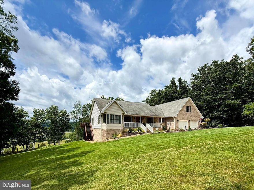 Discover your dream home at 137 Elm St, Franklin, WV – a haven of elegance and comfort designed for those who appreciate the finer things in life. This stunning two-story residence boasts thoughtfully crafted living space, offering a perfect balance of style, functionality and VIEWS.

As you step inside, you'll be greeted by an inviting entrance that sets the tone for the entire home. The heart of this property lies in its two beautifully appointed living areas, providing ample space for both relaxation and entertainment. The main living room adorns a cathedral ceiling, a stone corner fireplace and beautiful doors leading to the deck area.  The dining room seamlessly connects to a gourmet kitchen, creating an ideal setting for culinary adventures and memorable gatherings.

The kitchen is a chef's dream, featuring sleek stainless-steel appliances, ample counter space, a pantry, and custom cabinetry. The breakfast bar adds a touch of casual elegance, perfect for quick meals or entertaining guests while you prepare delicious dishes.

The main level has a oversized primary bedroom and bath with direct access to the WOW factor, large, covered deck.  The deck is complete with a hot tub and TV hookups for enjoying your favorite shows while soaking and being mesmerized by the countryside views.  Two additional, charming bedrooms that are ideally placed can also be found on the main level.

Ascend the stylish staircase to discover the private retreats on the upper level. The second primary bedroom is a true sanctuary, boasting luxurious space. The versatile bonus area offers additional living space, ideal for a cozy reading nook or a children's play area. With four well-appointed bathrooms throughout the home, comfort and convenience are assured for both family and guests.

For those who work from home, the dedicated office space provides a quiet and productive environment. .

The home's design maximizes natural light, creating a bright and airy atmosphere throughout. Hardwood floors, plush carpeting, and custom window treatments add warmth and sophistication to every room.

But wait there is more; a 2-bay attached garage, an under the house equipment garage, outbuilding and an unfinished basement that is plumbed for a 5th bathroom awaiting your vision for bonus living area or storage

Outside, you'll find a perfect blend of beauty and functionality. The property is located within the city limits of Franklin, WV.  With over 8/10 of an acre on a no thru street, a serene setting is offered while keeping you connected to modern conveniences.

This exceptional home is more than just a place to live – it's an opportunity to elevate your lifestyle. With its perfect combination of space, style, and comfort, 137 Elm St is ready to become the backdrop for your most cherished memories. Don't miss this chance to make your dream home a reality.