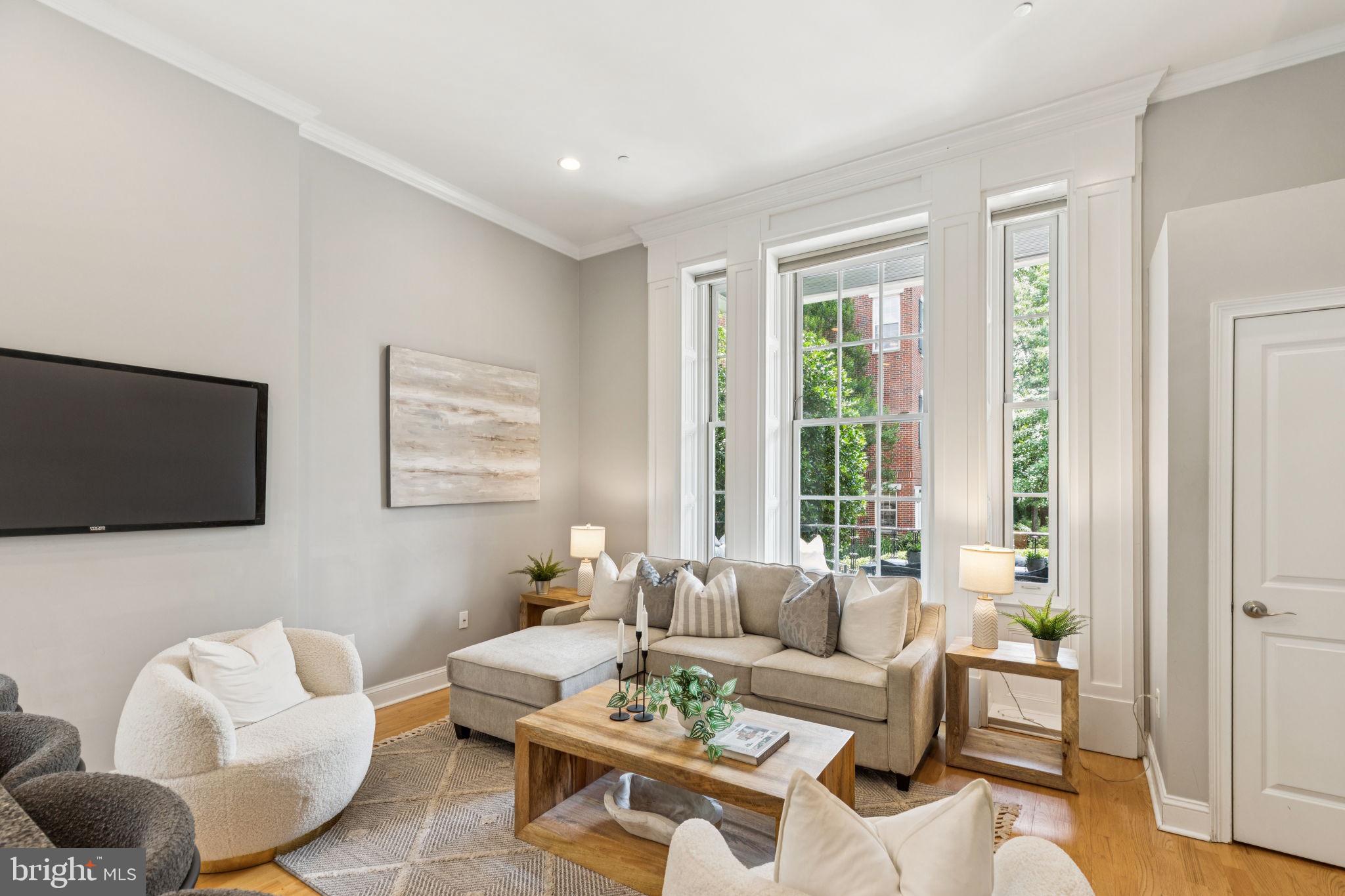Experience the pinnacle of luxury living at 4 Governors Court, a stunning condominium in Philadelphia’s prestigious Naval Square community! This rare and highly sought-after 1 bedroom, 1 bath unit offers both deeded parking and an enormous storage locker. Situated on the first level of the desirable Governor’s Mansion, a spectacular Greek Revival, boutique building, this home features an covered patio with antique restored iron work showcasing views of the lovely parade grounds! Enter into this stunning condominium and you will be in awe of this gorgeous living space featuring incredible architectural elements throughout: 14' ceilings, oversize windows w/ deep sills, & significant moldings. You will enjoy a lovely open concept living/dining area with plenty of sunlight streaming in from the large historic windows. The custom kitchen with island features freshly painted cabinetry, granite counters, upgraded recessed lighting & stainless Bosch appliance suite. The spacious owners suite has a large closet and more gorgeous historic windows. Beautiful, sunlit bath with window seat features granite and tile & upgrades. Oak hardwood floors, custom window treatments and neutral paint grace the entire living space. Stackable washer/dryer in unit. This unit also includes a huge storage locker located included in the basement of the building. Coat closet at the entryway of the home. Enjoy the ease of having the pool & state-of-the-art fitness center directly across from your building and the concierge close by. The dramatic community room in the Biddle Hall rotunda is perfect to reserve for private parties. Enjoy the outdoor amenities of the 20-acre park-like setting: including picnic areas, well-kept gardens & mature landscaping. With a gated entry and on-site visitor parking, convenience and security are paramount. Very close proximity to South Street Bridge, UPenn (0.7 mi), CHOP, HUP & Drexel, Rittenhouse (0.9 mi) & Fitler Square. Fantastic restaurants and cafes, such as Rival Bros Coffee, Friday Saturday Sunday (James Beard Winner), Illata BYOB, Pub & Kitchen, Southgate, Sabrina's & Loco Pez, are all just steps outside the gates. The new Heirloom Market by Giant and South Square Market are only a block away. Directly out the back gate you will find easy access to the Schuylkill River Park, including the Award Winning Trail & Boardwalk, Markward playground, Tennis Courts & dog park! Naval Square is a pet friendly community allowing up to 2 pets with no weight restrictions. Don’t miss this rare opportunity to own a sophisticated, move-in-ready home in one of Philadelphia’s most coveted communities! There is a Special Assessment with approximately 5 months remaining. Tax abatement expires 04/25/2026. Buyer's agent is responsible for confirming all taxes. Settlement can be ASAP.