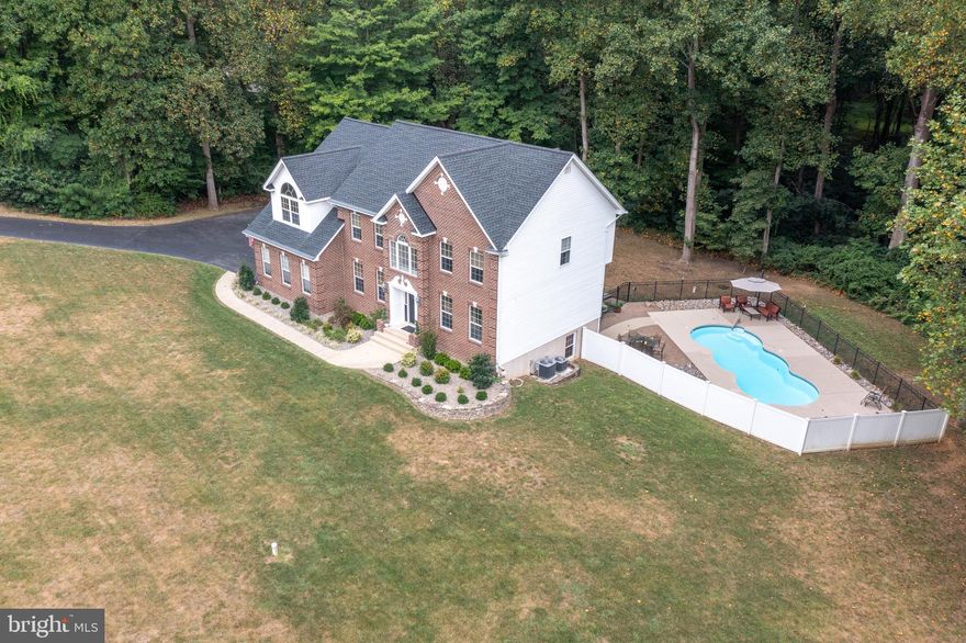 BIG, BOLD, BEAUTY! Almost 5,000 sq ft brick front colonial in sought after Huntingtown on 2 acres! Fall in love as you walk through the front door to the 2 story foyer. Make your way through the formal living room to your main level home office...perfect for those who work from home. 2 story family room with FP overlooking the private backyard. Kitchen is any chef's dream w/ backsplash, SS appliances, 42 inch cabinets, gas stove, granite, and kitchen island.  Morning room off of kitchen with doors leading to deck w/ private backyard and overlooking your personal saltwater pool...perfect for entertaining on those summer nights. Main level also includes...laundry, half bath, and formal dining room. Make your way to upper level to spacious primary bedroom w/ tray ceiling, siting room and walk in closet. Updated primary bath includes soaking tub, double sinks and shower. Upper level boasts 3 additional bedrooms and hall bath. Make your way to the lower level to rec room and additional room that could be used as a bedroom. Walkout doors to extensive hardscaping and pool. Pool features: fence, Hawaiian fiberglass, saltwater, and loop lock cover. 2 car garage. Roof is 1 1/2 years old w/ transferable warranty, and 2 carrier outdoor AC units as well as both indoor furnaces are only 4 months old! Better run...this one wont last long!!