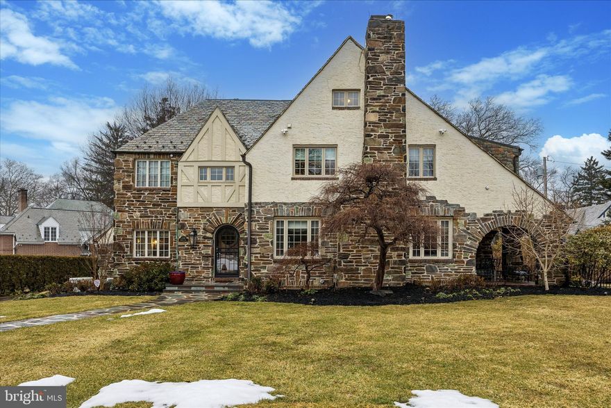 Nestled on one of the most coveted streets in Lower Merion, 239 Winding Way is a stunning, stone Tudor that seamlessly blends timeless elegance with modern upgrades. This stately home has been thoughtfully renovated and expanded, offering both charm and contemporary convenience. This home was completely reimagined during a three story plus basement renovation in 2007. No expense was spared in creating a home that blends classic charm with modern convenience. 

A slate walkway leads you to the entryway with parquet floors and a coat closet. To the left, a stunning office awaits, complete with built-ins, hardwood floors and a cozy window seat. Across the entryway the inviting living room features a beamed ceiling and gas stone fireplace, evoking the warmth and character of a bygone era. Arched French doors lead to a charming, brick-covered patio-perfect for relaxing or entertaining. The spacious dining room features hardwood floors, deep set windowsills, and charming French doors that lead to a covered brick patio. The heart of the home is the chef’s dream kitchen, equipped with double ovens, a gas cooktop, a warming drawer, a built-in microwave, a separate beverage fridge with an ice machine, 2 sinks, and an oversized pantry. Whether preparing an intimate dinner or hosting a gathering, this space is designed for function and flair. French doors lead to an additional room perfect for an office or playroom complete with built-ins. In addition, this floor features a beautifully appointed powder room and then access to the 2-car garage complete with Level 2 EV charger. Not to be forgotten is the mud room entered by a pocket door which has ample cubbies and closets to keep everything organized. 

Ascend the grand staircase to the second floor which luxury and functionality intertwine. The primary suite has 2 closets in the sleeping area, leading to an extraordinary dressing room. There are built-in drawers, two walk-in closets-one featuring a built-in safe. The primary bathroom is a spa-like retreat with double vanities, a large walk-in shower, a freestanding tub, and a private water closet. From the primary bedroom French doors welcome you to a  sunroom with a decorative fireplace and hardwood floors. This space is perfect for a home office or a serene retreat to relax and unwind. This floor offers a full laundry room complete with storage, folding space and hanging racks. The second bedroom includes its own ensuite bathroom, while a third bedroom sits adjacent to a hall bathroom with a separate tub and shower. There are heated bathroom floors in the primary bathroom and the hall bathroom at the top of the stairs.

On the third floor you’ll discover a large hall closet, two generously sized bedrooms, a full hall bathroom, and a cozy sitting area.   

The basement offers a carpeted finished space that is perfect for a home gym, playroom or whatever suits your lifestyle. This is also plenty of storage, including a dedicated wine storage area, along with the utility room housing a new, newer  heater, hot water heater and other essential systems to the house. 

The beautifully landscaped lot is a true outdoor retreat, boasting vibrant plantings of bulbs, roses, and lush shrubbery. Gather around the cozy firepit, grill on the gas grill connected to a dedicated line and admire the upgraded outdoor lighting. Additional features that truly set this home apart include a full-home generator for peace of mind,  and a prepped elevator shaft on all floors complete with a power source for future installation. Luxurious touches like heated floors in the primary bathroom and the bathroom at the top of the stairs elevate everyday comfort.Additional conveniences include keyless entry at  the garage and back door.

This is more than just a home-it is a lifestyle offering character, comfort and a prime Merion Station location. Walk to award winning Lower Merion Schools, restaurants, parks, library and easy access to center city and major highways.