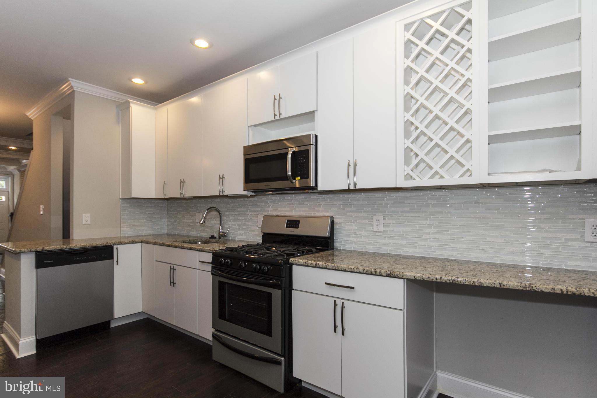 Reduced! Stunning renovation located in the desirable area of Locust Point. 2 bedrooms, 3.5 baths with a bonus room upstairs that could be used as an office. Gleaming hardwood floors with coffered ceiling on main level. Kitchen features 42" custom cabinets, granite counter tops and stainless steel appliances. Finished basement with full bath. Relax on the roof top deck.