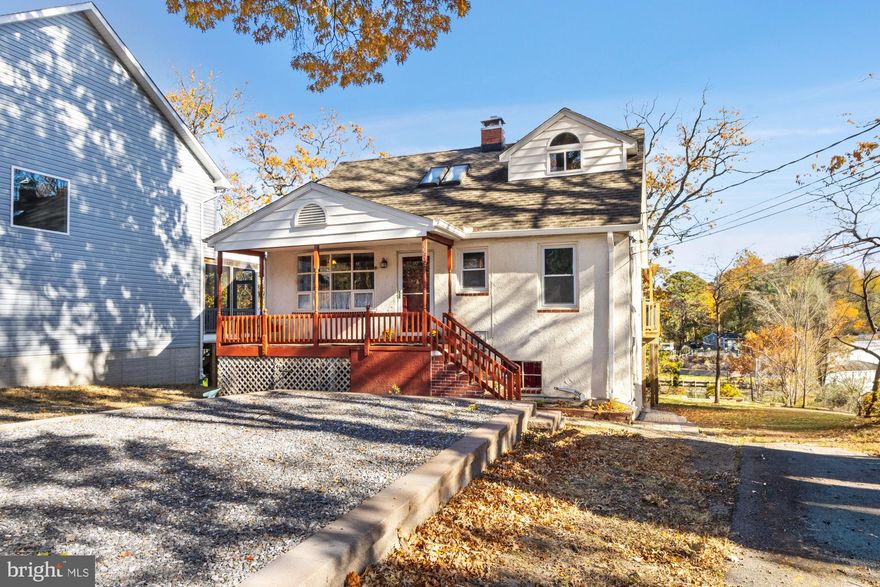 Discover this charming Cape Cod perfectly situated on the shores of Rock Creek. Enjoy sweeping water views from the spacious deck and your own private dock—ideal for boating, fishing, and relaxing by the water.  Rock Creek's deep water can accomodate a variety of watercraft from sailboats to power boats to kayaks. The main level of the home features a bright kitchen, a convenient bedroom and full bath, and a living room with easy access to the deck with pergola. The main level laundry room is located next to the bedroom, and would make a great walk-in closet/dressing room. Upstairs, find two comfortable bedrooms (both with fantastic water views) and another full bath. The fully finished lower level offers a complete apartment (incluidng a second laundry room!) with its own entrance—perfect for guests, in-laws, an au pair, or rental income—plus a workshop for hobbies or storage. Recent updates include a new furnace (2025), water heater (2025), chimney liner (2025), driveway and walkway to side door (2024), retaining wall (2022), and roof, (2017) giving you peace of mind for years to come.  With its versatile layout and serene waterfront setting, this home will delight you both inside and out!