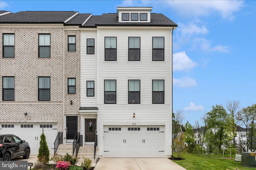 ***OPEN HOUSE SUN. 5/3 1:00-3:*** Welcome home to this nearly new, 2-year-old end-unit townhouse that perfectly blends comfort, style, and low-maintenance living. With a spacious 2-car garage and an impressive 8' bump-out on every level, this home offers exceptional space and an open, airy feel throughout. The heart of the home is the beautifully upgraded kitchen, featuring KitchenAid appliances, a wall oven, cooktop, quartz countertops, large pantry, upgraded cabinetry, and a large island—perfect for entertaining. Just off the kitchen, step onto your private balcony and unwind while taking in peaceful views of the creek—an ideal spot for morning coffee or evening relaxation while watching deer pass by. The adjoining dining area flows seamlessly for gatherings, while the light-filled living room showcases stunning mountain views. Those same scenic views continue from the front bedrooms, creating a serene and inviting atmosphere throughout. Upstairs, the spacious primary suite is a true retreat, highlighted by a tray ceiling and a luxurious Roman bath with double shower heads and dual sinks. The hall bathroom also features dual sinks, offering added convenience. A dedicated laundry room with built-ins makes everyday living even easier.  Additional upgrades include enhanced kitchen and bathroom cabinetry, upgraded flooring throughout, upgraded light fixtures, a triple dormer window, and an EV charger in the garage.  Enjoy the ease of an HOA that takes care of lawn mowing and sidewalk snow removal, giving you more time to relax and enjoy your surroundings. For added recreation, a community pool is available for an additional fee.  This home truly offers the perfect combination of thoughtful upgrades, comfort, and scenic beauty—all in a low-maintenance lifestyle.