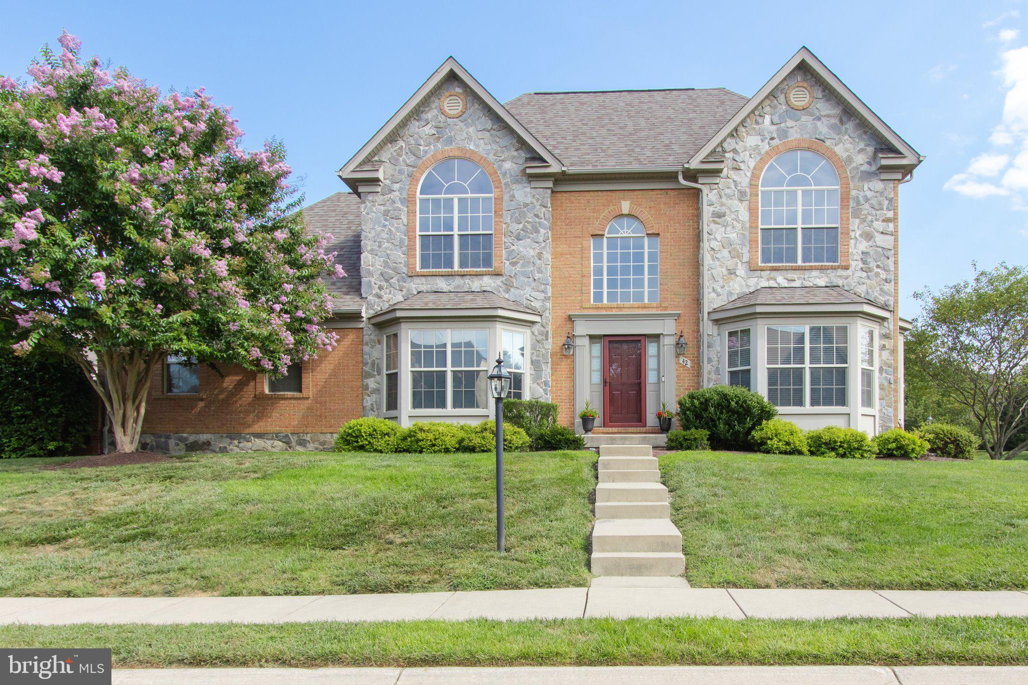 Welcome to Elegant Living in the Amenity-Rich Gated Community of Beallair in Charles Town, Wv.
Perfectly sited on a beautiful corner lot adjacent to the community park, this exquisite former model home from Wormald Builders offers luxurious living in a park-like setting—with all the comforts and conveniences you could hope for.
From the moment you step into the open grand foyer, you’ll be welcomed by warmth, natural light, and timeless design. Stunning bay and arched windows, rich hardwood floors, and custom mouldings—including crown moulding, shadow box trim, and built-ins—highlight the home’s impeccable craftsmanship.
The heart of the home is a spacious great room with a cozy fireplace, perfect for gatherings or quiet evenings. The gourmet kitchen features granite countertops, ample cabinetry, and an easy flow to both casual and formal dining areas via a functional Butler's space.
The main-level primary suite is a true retreat with it's floor to ceiling bay windows, hardwood floors and custom build headboard. The main-level suite is completed with a spa-like bath including a jetted soaking tub, separate shower, private water closet, and generous walk-in closet. The four additional bedrooms and 4.5 beautifully appointed baths ensure space and privacy for family and guests.
Enjoy the ease of main-level laundry with utility sink, and a fully finished lower level offering even more living and entertaining space.
Step outside to your private stamped concrete courtyard, ideal for relaxing or entertaining. With the community park just steps away, walking trails, a pool, and future fitness center being all part of the amenity-rich gated neighborhood, every day feels like a getaway.
Commuting is a breeze with quick access to all points in the DMV area and you'll be able to maintain your electric vehicle as it rests in the fully finished garage with epoxy flooring and car charging port. You'll be able to rest easy and enjoy life because the HOA fee covers the cost of lawn maintenance, leaf raking, snow removal, and trash pickup, so you can focus on enjoying your beautiful surroundings. This home blends elegance, comfort, and convenience like no other—come experience it for yourself today.
