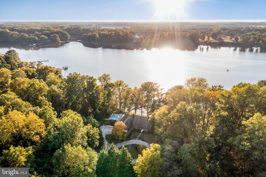 Extremely well built and elevated waterfront home sited on 3.87 acres plus an additional 3-acres for owners exclusive enjoyment featuring stunning views of the Corsica River, private dock, heated salt water pool, three-car garage, and is conveniently located within a few minutes from town! This property is the perfect private setting with rolling lawns, pastures, mature trees, and a long winding driveway to your lovely oasis. The home boasts over 4000 sq. ft. of finished living space and includes a main level primary suite, comfortable floor plan, additional bedrooms on the upper level and finished lower level / exercise room. Other details include: hardwood floors throughout, high vaulted ceilings, bright natural light,  gourmet kitchen with granite counters, sunroom overlooking the water and pool, a screened in porch, fully fenced in rear yard, storage shed, and so much more! New BAT (Best Available Technology) Septic System Installed. Don't wait - you will love living here!