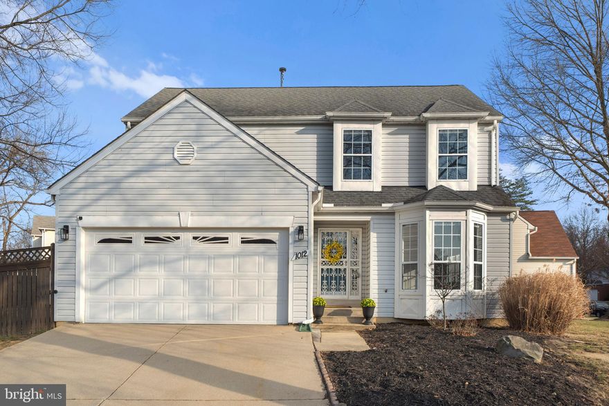 FANTASTIC FIND! This BEAUTIFULLY UPDATED, meticulously maintained, MOVE-IN-READY 4-bedroom home is tucked away in a quiet, LOVELY UPSCALE NEIGHBORHOOD, just minutes from National Harbor, the Beltway, and the Wilson Bridge.  **   With nothing to do but unpack, you'll enjoy the added peace of mind from the INCLUDED ONE-YEAR HOME WARRANTY!  **  Upon arrival, you’ll immediately appreciate the EXPANSIVE CORNER LOT—over a quarter acre—enhanced by stately mature trees and a FULLY FENCED BACKYARD with shed.  **   Inside, extensive crown molding, wainscot trim, and luxury plank flooring throughout most of the main level create a polished  feel.  BRAND-NEW CARPETING adds comfort to the large, flexible living/dining space, with its elegant bay alcove, and continues up the open staircase and throughout the second level.  ** The OPEN-CONCEPT KITCHEN is a showstopper, featuring white quartz countertops, a striking tile backsplash, stainless steel appliances, and stylishly painted cabinetry. The adjoining breakfast area opens to a LARGE DECK—perfect for entertaining—and flows seamlessly into the inviting FAMILY ROOM with a REAL WOOD-BURNING FIREPLACE. This level also includes a half bath,  laundry, and direct access to the attached TWO-CAR  GARAGE.  **  Upstairs, the spacious PRIMARY SUITE offers a relaxing retreat with vaulted ceilings, TWO LARGE WALK-IN CLOSETS with built-in organizer systems, and a BEAUTIFULLY REMODELED ENSUITE BATH. Two additional bedrooms feature charming box-window bump-outs, while all three secondary bedrooms share an updated hall bathroom.  **  The FINISHED BASEMENT provides flexible additional living space, featuring a full bath, abundant storage, and an exterior entrance with stairs leading to the backyard—ideal for use as a recreation room,  a potential 5th bedroom, or Guest/ IN-LAW SUITE!   * *  This home truly delivers THE BEST OF BOTH WORLDS—close to the city commuting, shopping and dining, yet enjoying the serenity of a peaceful small community-type setting with a large lot!   Homes like this, at this price point, are RARE!  Mortgage savings may be available for buyers of this listing. Schedule your PRIVATE TOUR today!