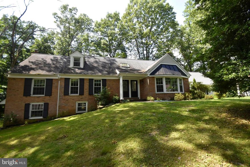 766 Mancill Road is a  charming, renovated 5 bedroom, 4.5  bath brick cape with over 4000 square feet of finished, sun-filled living space on 3 levels.  Skylit vaulted ceilings, tall sliding doors, and wide bay windows allow ample ambient light to flow through the first floor.  Wide arched doorways and a two-story foyer create the ideal open floor plan that features a family room & living room with fireplaces and a formal dining room off the kitchen. A step-down mudroom has access from the 2 car garage and an outside entrance leading to the front flagstone walkway.  The granite island seats 4 with ease and the kitchen is tastefully adorned with cherry cabinets, a tile backsplash, and lovely hardwood floors. There is a first-floor primary bedroom suite complete with a double bowl vanity, glass-enclosed tiled shower,  corner tub, and a private commode. His and her walk- in closets complete the suite. A second bedroom and full hallway bath with laundry facilities complete the first floor. Upstairs there are three large, carpeted bedrooms and one full bathroom.  The enormous, paneled finished daylight walk-out basement features a wood-burning stove, built-in bar, an office/bedroom, and a full bathroom.  Set on a mature 3/4 acre lot, the covered rear deck makes a wonderful outdoor living space complete with a fieldstone, wood-burning fireplace.