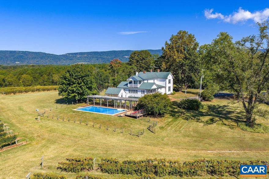 Centrally located in the Monticello AVA, and in the center of the Nelson 151 Craft Beverage Trail, Cardinal Point Vineyard & Winery has been in business since 1985. Surrounded by breathtaking Blue Ridge Mountain views, this well established family run 81 acre winery is ready for its next owner. The heart of the property is the classic 5 bedroom 1890s farmhouse. Featuring gleaming original hardwood floors, period fixtures, dual primary suites, stunning cherry kitchen, sunroom, and inground pool, the house is currently operated as a hugely popular short term rental. Of the  35 open acres 7 are in established vineyard production, with 4 acres currently fallow and ready for new vines. The winery features a contemporary 1080sqft tasting room with office & restrooms, seating in the indoor mezzanine/outdoor covered deck/patio, and 2880sqft of production and storage space. Public amenities also include an outdoor stage, disc golf, and open space for picnicking & play. The property is supported by numerous outbuildings including a 5040sqft open equipment shed with work and storage spaces as well as a conditioned office. The house and winery are both fully energized by solar power, the house also has generator back-up. Opportunities abound!,Cherry Cabinets,Wood Counter,Fireplace in Kitchen