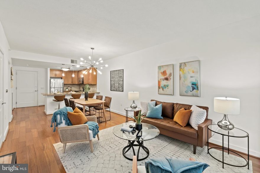 Looking for a freshly painted, move-in ready, 1 bedroom condo in the Arlington area? Here it is! ***Enter the lobby with seating areas, meeting and party rooms, TV & fireplace for gatherings, as well as fenced outdoor spaces - great for dog walks.*** Lovely & scrupulously maintained public spaces, newly renovated hallways & elevators. *** Once inside this spacious 693 sq ft condo, and you will be instantly enamored by the amount of natural light and thoughtfully designed floor plan, dressed with gorgeous details: open concept  kitchen with granite countertops, stainless steel appliances, beautiful wood floors, neutral in-trend white paint, new light fixtures, and of course the wine fridge. *** The balcony off of the living area has room for chairs to enjoy the warmer weather. ** The large main bedroom is carpeted and boasts a spacious closet with beautiful built-ins that you won't find in many other condos. **The bathroom has custom under-the-sink storage, and a sand-toned tiled tub/shower, as well as newer washer and dryer. ** Check out the Rooftop Terrace with fabulous 360 degree views of the Washington DC Metro Area, community pool & well outfitted Gym. Unmatched Location, especially for the Fourth of July fireworks...One Garage parking space, one storage space, and bike storage. ** Just steps to Ballston Metro, easy access to all major commuter routes into DC, Arlington, Alexandria and major government & private employers. *** Your condo fee of  $464 per month to Residences at Liberty Center includes the following: trash (trash room on same level as condo), water, sewer, and amenities...outdoor Rooftop Pool  (Mon-Fri:  11 a.m. - 8 p.m.  /  Sat-Sun: 10 a.m. - 8 p.m.), Roof Deck w/ Views of Washington DC Monuments, Club Room w/ Fireplace and Kitchenette, Fitness Center, Controlled-Access parking, Bike storage room, 24 hour Staffed Front Desk, Elegant Lobby, Private Courtyard, Food Grill Facilities in Courtyard. **Utility service providers to the condo: Dominion Energy, Verizon Fios Cable and Internet.***Please contact your real estate agent to pre-schedule your showing TODAY!!*** Disclosure - seller is related to agent. As-is items include water heater and HVAC, which are in working order. Documents include floorplans, amenity info, surrounding businesses, video, and 3D Matterport *