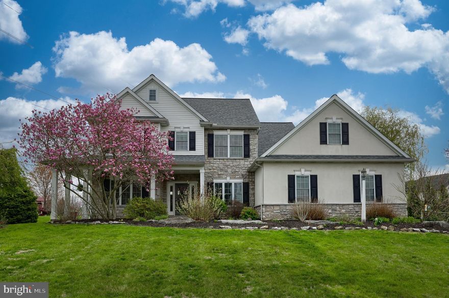 Welcome to this charming colonial farmhouse in the desirable Windy Hill neighborhood of West Lampeter Twp. Situated on a spacious .81-acre lot, this beautiful home features a classic wraparound porch, mature landscaping, and a large side yard—perfect for relaxing or entertaining. Step into your backyard oasis, complete with an in-ground pool and diving board—ideal for summer gatherings with friends and family or simply unwinding on warm afternoons. Inside, you'll find a versatile front study or home office and a cozy sitting room with gleaming hardwood floors. The heart of the home is the open-concept kitchen and family room, centered around a warm gas fireplace—a welcoming spot on chilly evenings. The kitchen offers a generous dining area and a large island with seating for four, perfect for meal prep, entertaining, or casual dining. Upstairs, the primary suite is a true retreat, featuring a jetted tub, separate shower, and spacious walk-in closet. Three additional bedrooms provide plenty of room, with two offering walk-in closets. There is also direct access to the attic area above the garage. The finished lower level includes a fifth bedroom and a family/game room—ideal for entertaining, relaxing, or hosting guests. The oversized two-car garage offers ample room for vehicles, storage, and all your tools and toys. All this just steps away from Windy Hill Park, combining comfort, space, and a wonderful community setting.