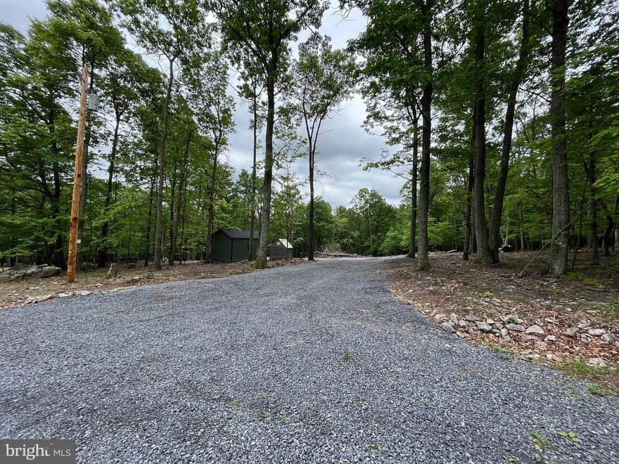 Introducing a magnificent five acre gently sloping lot, partially cleared and  nestled amidst a serene wooded landscape perfect for those seeking privacy and seclusion.  This lot  features a generous building envelope, allowing ample space for a spacious residence, garage, and outdoor amenities. This lot also has Electric , Well, and a 4 Bedroom Septic installed  in  2023.  Whether you're looking to build a permanent residence or a vacation home, this wooded five acre rolling lot is the perfect place.    Don't miss the opportunity to make this exceptional property your own.