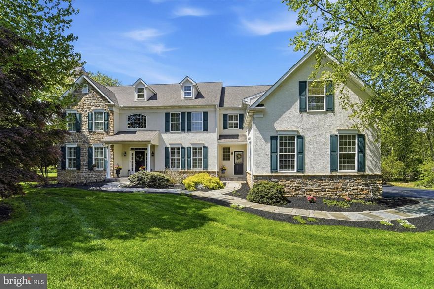 Tucked away on a coveted cul-de-sac in Garnet Valley within the highly rated Garnet Valley School District, 7 Lockhart Drive is an elegant, meticulously maintained residence resting on a premium, private 1.26-acre lot. With four bedrooms and four & a half bathrooms, this home stands out for its added versatility as it also features a large bonus room AND dedicated office - providing exceptional flexibility for guests, work-from-home needs, or extra living space.  The home’s striking exterior, custom walkway, and welcoming front porch set the tone for what awaits inside. Thoughtfully designed hardscaping and lush landscaping elevate the home’s curb appeal, while the property is complemented by the tranquility of surrounding wildlife. Step inside to an expansive foyer, showcasing gorgeous hardwood flooring that extends throughout the entire main level, complemented by plantation shutters and updated lighting. The first floor includes a formal dining room, a sophisticated sitting room with a gas fireplace, and a private office with a closet—ideal for a main-level bedroom if desired. The beautiful kitchen serves as the heart of the home, showcasing granite countertops, an oversized island with seating, gas range, double ovens, built-in desk, soft-close cabinetry, and updated hardware. The kitchen flows into a breakfast area and cozy sunroom - an ideal setting for your morning coffee. Just beyond, a spacious family room anchored by a two-story grand stone gas fireplace adds warmth and charm. Completing this level is a thoughtfully-designed laundry and mudroom with custom cabinetry and direct access to the three-car garage. Upstairs, a cozy window-seat landing creates the perfect nook before leading into the stunning primary suite. This serene retreat features a spacious sitting room, two walk-in closets, and a luxurious bathroom appointed with travertine tile, heated floors, dual vanities, a jetted tub, and rain shower. Down the hall, you’ll find a guest bedroom with an en-suite bathroom, along with two additional generously sized bedrooms and a hall bathroom.  A large bonus room above the garage offers incredible flexibility—ideal as a fifth bedroom, playroom, or home office. A landing overlooking the family room completes the second level. The finished basement is a true showstopper—highlighted by a custom stone-pillared bar set against beautiful stone tile flooring, complete with a wine rack, dual mini-fridges and extra seating. A versatile home-gym, full bathroom and home theater area add to the appeal, while a cozy fireplace creates the perfect setting for entertaining friends or movie-night with family.  Outdoor living is nothing short of exceptional, featuring a Trex deck with custom flared stairs that descend to a beautifully crafted brick paver patio, complete with a built-in fire pit, seating wall and custom lighting. 7 Lockhart Drive offers a private, resort-caliber setting designed for elevated entertaining and refined outdoor living. Not to be overlooked, the expansive backyard is enhanced by an in-ground sprinkler system, mature landscaping, and a rare blend of functional space and natural beauty. Major updates include: dual-zone HVAC (2019), hot water heater (2024), numerous interior upgrades throughout. Offering easy access to major roadways including 202, Rt 1, and I-95, making commuting to Philadelphia, Wilmington, and beyond effortless. Residents will enjoy close proximity to everyday conveniences, upscale dining, and local favorites, as well as beloved community destinations like Booths Corner Farmers Market and nearby parks. Outdoor enthusiasts will appreciate access to scenic trails, open space, and nearby attractions such as Ridley Creek State Park and Longwood Gardens. Garnet Valley is known for its strong sense of community, natural beauty, and top-tier schools—making this an exceptional place to call home. Book your showing today!