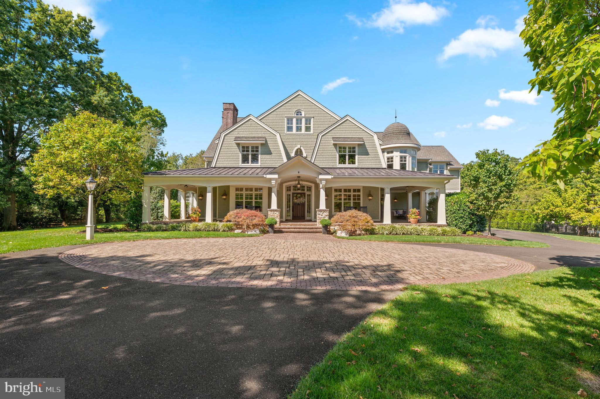 Welcome to 809 Brushtown Road, this residence redefines grandeur and elegance with exceptional craftsmanship throughout the home. Set on an almost 3 acre lot of professionally landscaped grounds, this home spans more than 7,000 square feet of refined living, designed for both family life and world class entertaining, both inside and out! This property is uniquely appointed with a newly constructed in law suite, above the oversized garage, with its own kitchen to ensure privacy and comfort for extended family and guests. In total, this home boasts 6 bedrooms, 7 full bathrooms, and 1 half bathroom in the main home. Enter through the private gated entrance, and you will immediately be drawn to the cobblestone driveway detail, the lush grounds, and this jewel box Colonial home with a distinctive shingled and exterior gambrel roofline, and a magnificent wrap around porch! White oaks floors, soaring ceilings, and curated finishes set a timeless tone. Step inside, and to the right of the grand foyer is a spectacular dining room with a coffered ceiling. The gourmet chef's kitchen is the heart of the home! The kitchen includes an enormous marble island with seating for 7, and the perimeter countertops are soapstone with a large soapstone sink. The kitchen boasts custom cabinetry and range hood, and top of the line Sub Zero/Wolf appliances including a 48 inch dual fuel range with 2 ovens, 2 dishwashers, and a full 36" refrigerator and 36" freezer. Adjacent to the kitchen is a Craft/Flex room offering endless possibilities for crafting, baking, holiday food preparation, a caterers workspace, etc! This room offers yet another large center island, a refrigerator, an oven, a double faucet sink and soapstone countertops for all of your crafting or entertaining needs. The kitchen flows directly into a sunlit breakfast room, overlooking the backyard and outdoor living spaces. Enjoy the ease of open living with a natural flow into the cozy family room, ideal for everyday comfort and entertaining. The main floor is further elevated by a study, highlighted by custom wooden beams, and a gas fireplace, creating a warm and inviting retreat. This room includes a spiral staircase taking you down the incredible lower level! The main floor also features a sunroom, with a custom built in wet bar with 2 SubZero beverage refrigerators. The main level is thoughtfully designed for everyday living, complete with a full bathroom, powder room, pantry and mudroom that combine both convenience and comfort. The incredible attention to detail continues as you ascend to the upper levels. The primary suite exudes elegance with its coffered ceiling, and a private office, a fireplace, an outdoor covered deck and a thoughtfully designed coffee bar. The luxurious primary ensuite features his and her bathrooms, offering a spa-like retreat. Some of the features include, marble countertops, a custom shared marble shower, marble floor and air jet freestanding soaking tub. The primary suite also features his and hers walk-in closets, providing abundant storage. The 2nd floor includes 4 additional bedrooms and 3 full bathrooms. The 3rd floor also hosts its own bedroom and full bathroom, perfect for guests. The laundry room is located on the 2nd floor. The lower level is the ultimate family recreation space recently customized with a theatre room, a gym, various living areas to host various games, an infrared sauna, a wet bar and full bathroom. Almost as expansive as the home, the oversized garage offers room for 8 vehicles - an incredible space you have to see to believe! The outside features an outdoor living and dining area that overlooks the sun kissed pool with a slide - perfect for family fun and entertaining! 809 Brushtown Road is situated in the top rated Wissahickon School District, and close to top private schools, clubs, shopping, dining, the regional rail, and major highways. This haven is more than just a home - it's a lifestyle!