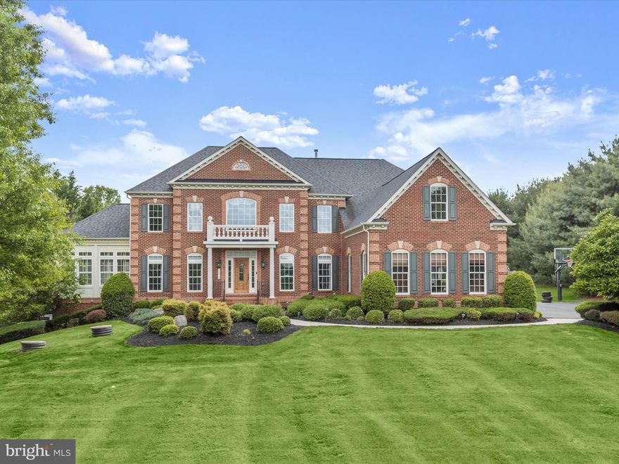 Fall in love with this truly spectacular former model home, with end-to-end luxury finishes and appointments that are sure to offer a lifetime of worry-free living and entertaining. Inside, a storied foyer with a decorative marble floor is sided by living and dining formals that unfold into a beautiful open floor plan with rooms defined by architectural columns and strong moldings. The dining room is enhanced with a marble floor and trim ceiling accent. A pair of stately columns transition from the formal living room into the quintessential NV conservatory adorned with plantations shutters and a tray ceiling.   Central to the open plan, a two-story great room offers a soaring wall of windows that draw your eyes upward to the deeply coffered ceiling, while a gas fireplace and integrated media built-in offer convenience and luxury.  Adjacent, the gourmet kitchen and breakfast area offer atrium access to the wrap-around rear deck.

A commanding center island with breakfast bar and pendants is encircled by cabinetry, stainless steel appliances, and a designer backsplash. Prep your favorite dish on a gas cooking station, Bulter’s service pantry, and bountiful storage in the walk-in pantry.  The kitchen is sided by a secondary rear stair, and the mud room offers a drop area with built-in cubbies conveniently located near the garage access door. 

A winding stair with classic ambiance rises to the upper-level bedrooms with a carpet runner that escorts in style to the upper level.  The Owner’s Bedroom Suite and Secondary bedrooms each offer an attached bath and walk-in closets. The tastefully soft owner’s suite is certain to impress with a central bedroom space defined by a tray ceiling and sided by a spacious sitting area for relaxing with a good read. Enjoy a luxurious spa-like soaking tub, separate vanities, linen storage, and a walk-in shower. Walk in closets include an expansive walk-in dressing closet that will surely accommodate any wardrobe and shoe collection. 

Entertainment options are endless and include a fully finished walk-out lower level.   A spacious recreation room offers the beauty of hardwood engineered floors that are low maintenance, and this versatile space is complemented by wrap-around wet bar, full back-bar and adjacent flex room. The lower level is completed by a media room outfitted with acoustical walls and soft sconce lighting creating a theater vibe.  This dreamy former model home is the perfect combination of comfy and stately and has an unmatched picturesque setting. Come home and rejuvenate every day with luxury, quality, and enduring beauty.