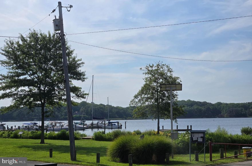 Wake up to this gorgeous water view year round from the sunroom of this beautiful 2 bedroom, 2 full bath, nice corner lot home located in an amenity rich neighborhood with 5 neighborhood beaches, play grounds, basket ball courts, neighborhood docks, pier and boat launch right across the street. Undoubtable the number 1 spot for the 4th of July fire works over the water and tons of other community activities. Home features two nice size bedrooms, primary with full updated bath,  recently updated hall bath, kitchen cabinets and counter tops, beautiful vinyl plank flooring, Front  paver patio to enjoy that summer breeze off the water