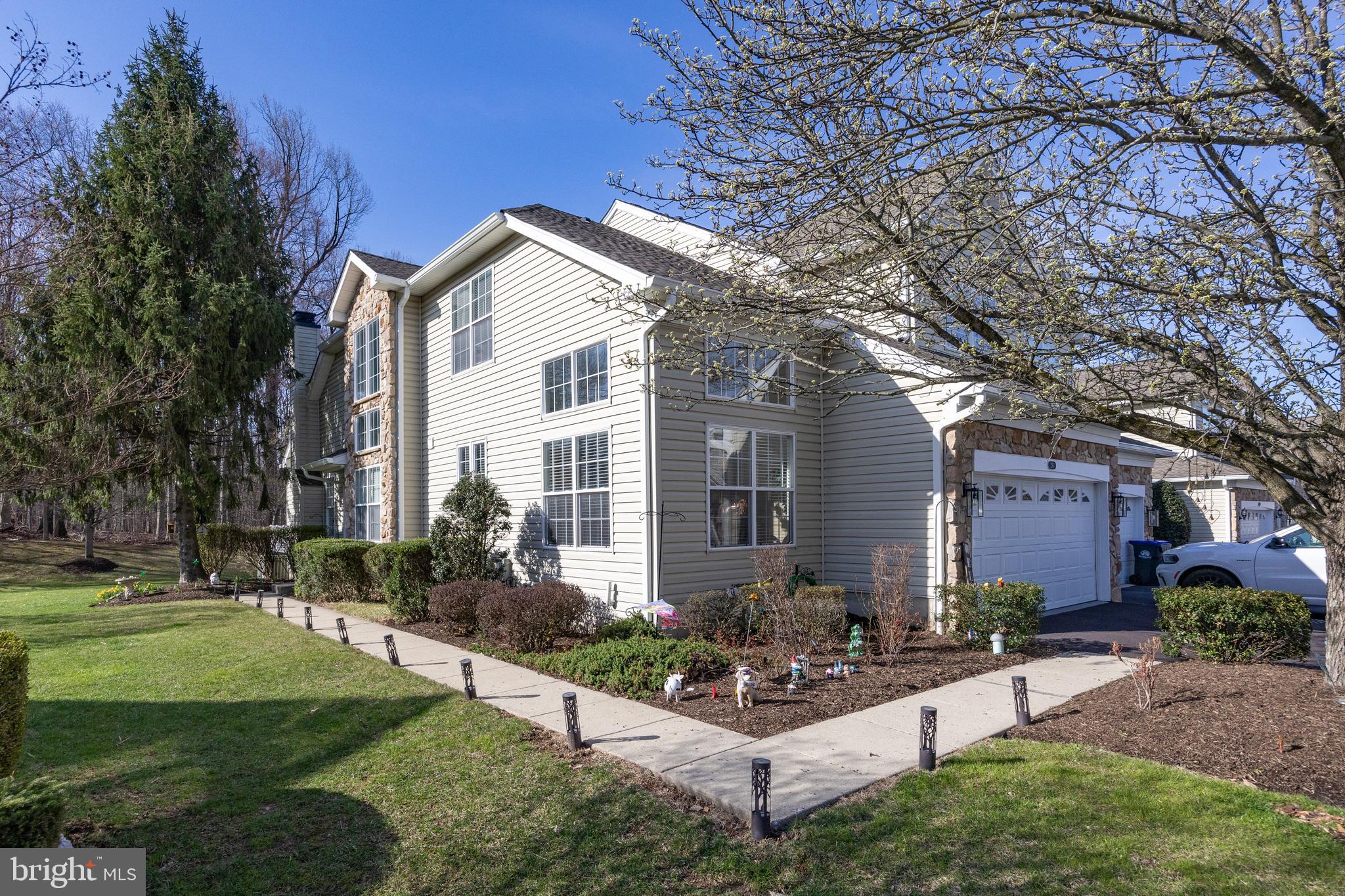 **Luxury Living in a Private Setting!**
This stunning 2-story East facing end-unit carriage home greets you with a grand entryway and a beautifully turned staircase, leading to a spacious living room with soaring vaulted ceilings, a cozy gas fireplace, and sliding doors that open to a newly renovated rear deck. The bright and airy eat-in kitchen is a chef's dream, featuring a center island, 42" raised-panel cabinets, a built-in desk, and a large dining area—perfect for entertaining guests.
The first-floor master suite is a true retreat, offering two modern walk-in closets and a luxurious, fully tiled bath with a double vanity, separate shower, and a soaking tub. A tiled hall bath with a double vanity provides added convenience for guests.
The fully finished basement expands your living space and includes a full bath and walk-out access, ideal for hosting guests or creating a recreational area. With abundant natural light flowing through the numerous windows, this home beautifully integrates indoor and outdoor living.
Situated on a premium lot, this end-unit home is part of a community with exceptional amenities, including a pool, clubhouse, tennis courts, gym, and a nature trail. Conveniently located near shopping, major roadways, the R5 train station, and all local amenities, this home offers the perfect blend of comfort and convenience.
Additionally, you’ll enjoy peace of mind with a brand new roof installed in 2024. This home is truly a must-see—schedule your tour today!