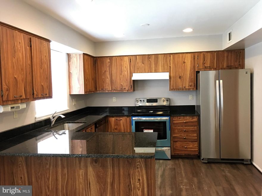 New remodeled brick Townhouse w/ New paint, New HVAC, New Waterproof floor on 3 levels. Almost 2500 sf. finished living space, back to woods/trail, fenced back yard. Additional large bedroom w/ large window, full bath in basement. Fireplaces, large deck, NEW SS appliance and new granite countertop! New Washer/Dryer! Extra storage on the side and move-in ready. ATHOLTON!! Like a new house!