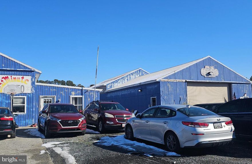 Industrial site with two pole buildings, one is 60'x100' with a truss roof, slab floor. Small office area, no bathroom facilities, two overhead doors, 12'x18', currently heated with wood stove.  Currently rented to paint/body shop.  Second building is approximately 2,225 sq. ft. with 225 sq. ft. of finished office space with a waiting room, storage, bathroom, office, and elec. bb. heat.  Main area has two overhead doors, front and rear.  Metal siding and roof. This building is currently leased to an auto repair facility.  Both buildings need repair.  Property is sold as is.